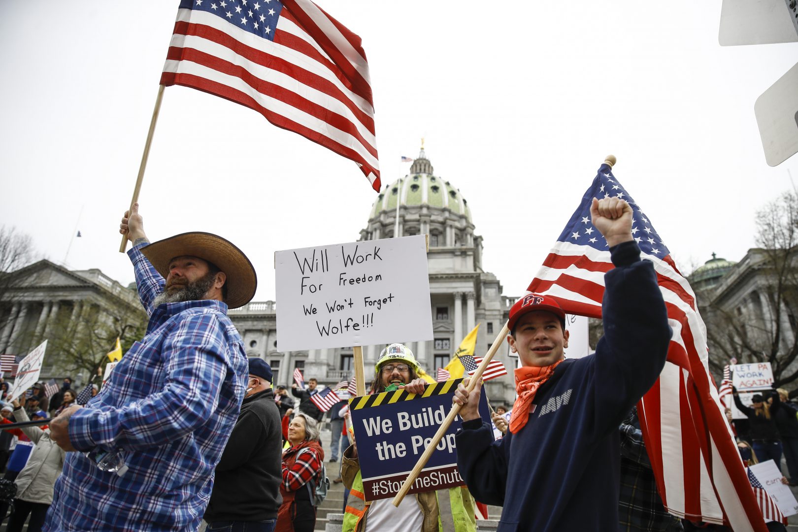 Protesters demonstrate at the state Capitol in Harrisburg, Pa., Monday, April 20, 2020, demanding that Gov. Tom Wolf reopen Pennsylvania's economy even as new social-distancing mandates took effect at stores and other commercial buildings.