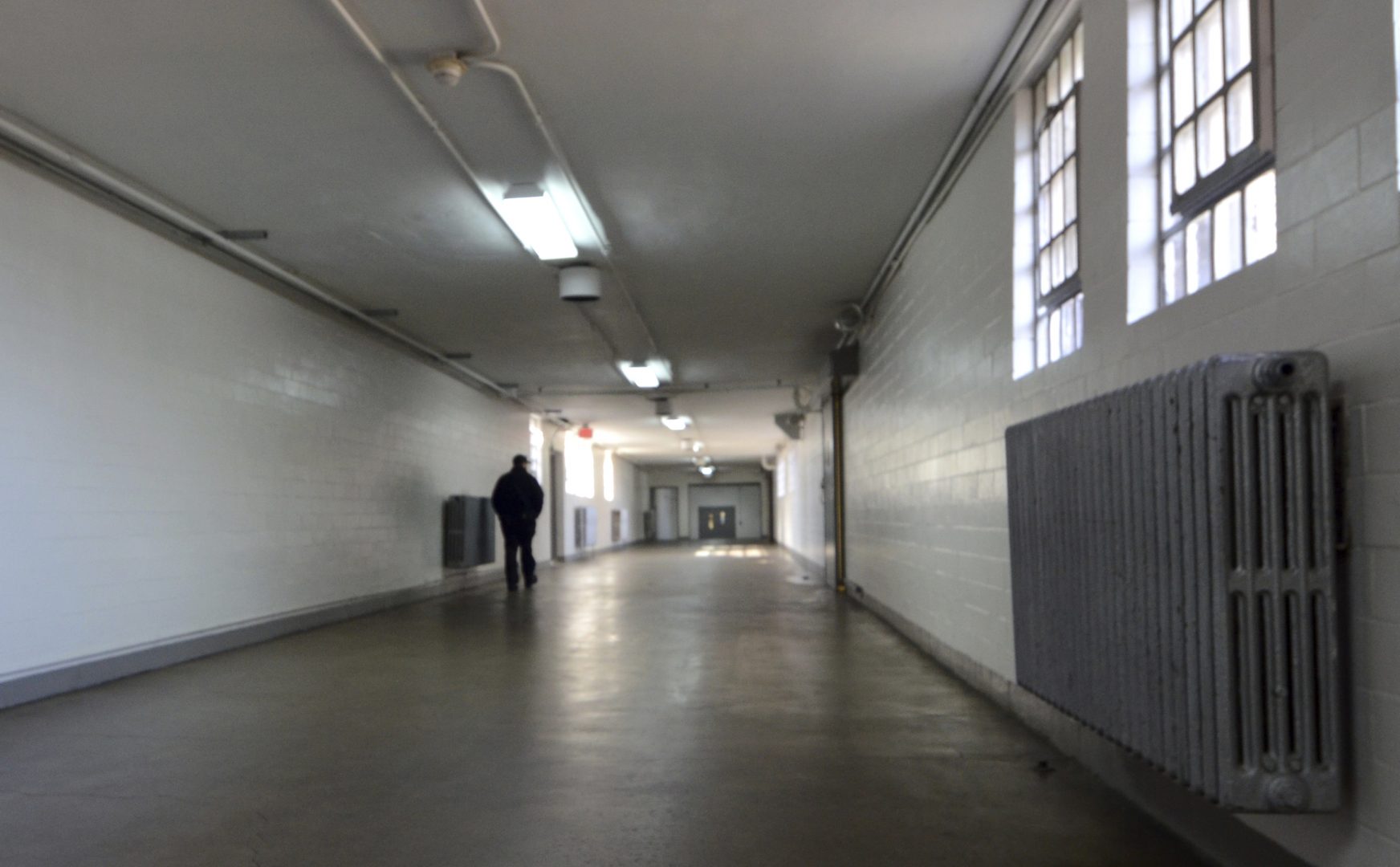 FILE PHOTO: A corrections officer walks down a hallway in a building at the State Correctional Institution at Camp Hill, Pennsylvania, on Jan. 13, 2017, in Camp Hill, Pa.