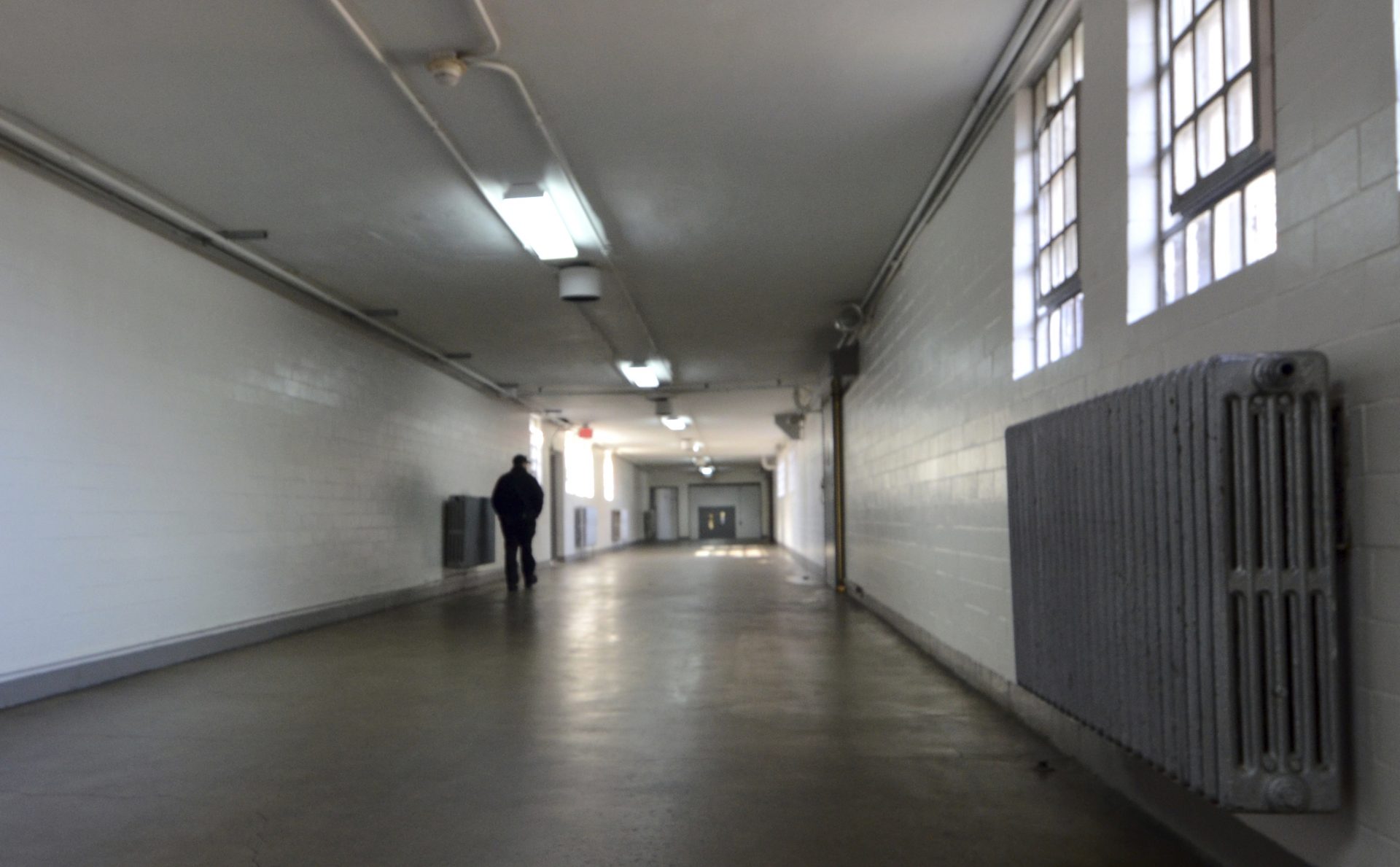 A corrections officer walks down a hallway in a building at the State Correctional Institution at Camp Hill, Pennsylvania, on Jan. 13, 2017, in Camp Hill, Pa.