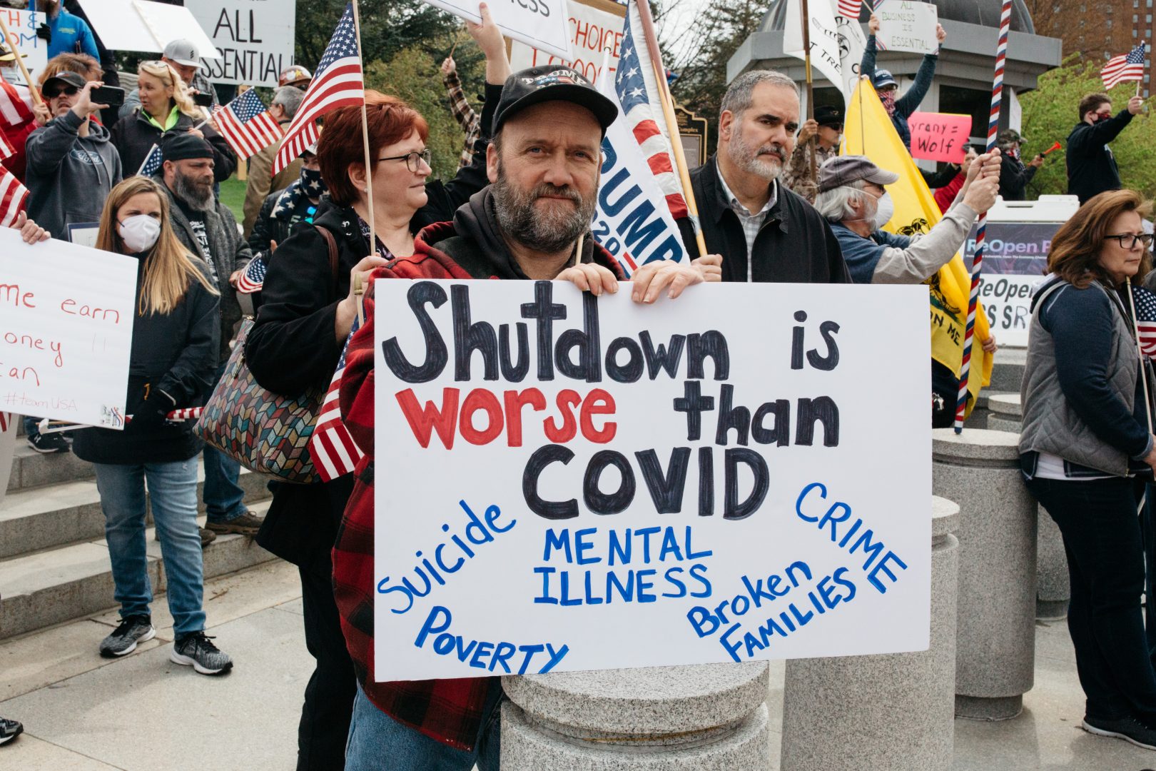 A man holds a sign at a rally to 