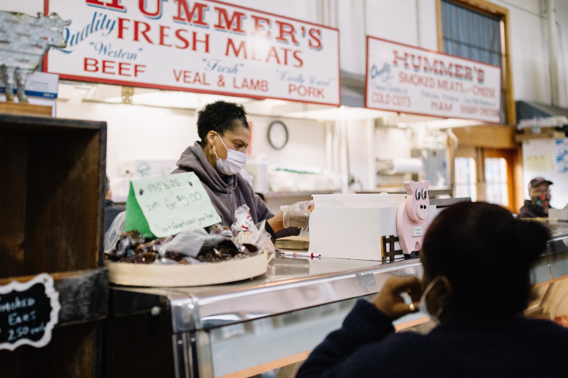 A worker wearing a mask packages meat for sale at Broad Street Market in Harrisburg on April 10, 2020. The market is much quieter since the coronavirus pandemic effectively shut down the region.