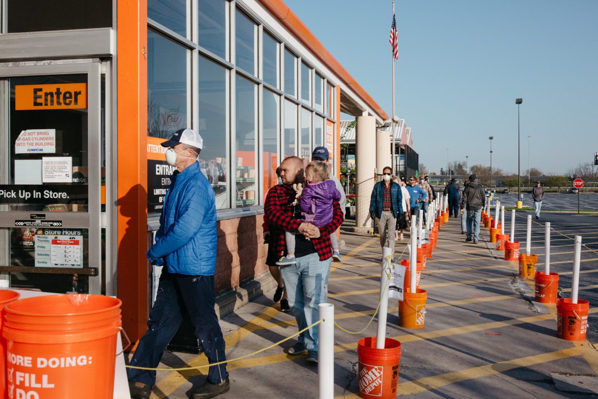 Customers line up outside a Home Depot store in Lancaster County on April 19, 2020.