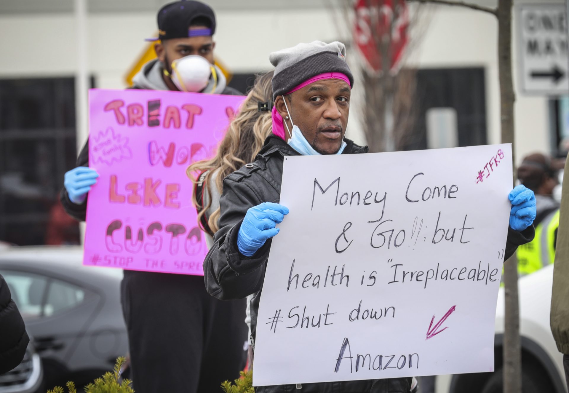 Gerald Bryson, left, join workers at an Amazon fulfillment center in Staten Island, N.Y., protesting conditions in the company's warehouse, Monday March 30, 2020, in New York. Workers say Amazon is not doing enough to to keep workers safe from the spread of COVID-19. "They say we going by CDC standards, but when we call the CDC they are not," said Bryson. "I got grand kids at home, I got kids, I am not doing it."