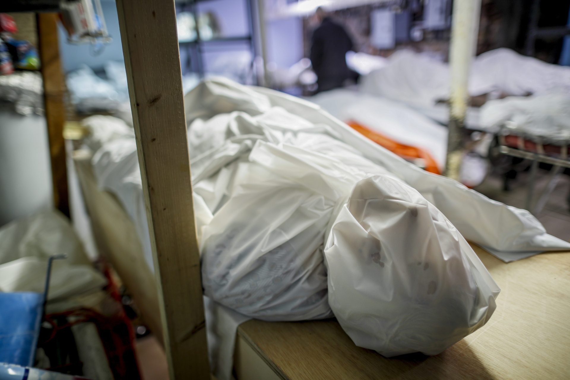 Bodies are wrapped in protective plastic in a holding facility at Daniel J. Schaefer Funeral Home, Thursday, April 2, 2020, in the Brooklyn borough of New York. The company is equipped to handle 40-60 cases at a time. But amid the coronavirus pandemic, it was taking care of 185 Thursday morning.