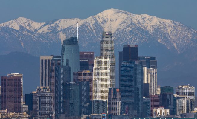 The San Gabriel Mountains are seen under a clear sky beyond downtown Los Angeles. Air quality in the U.S. and elsewhere has been improved by reduced traffic from coronavirus restrictions and weeks of rainstorms.