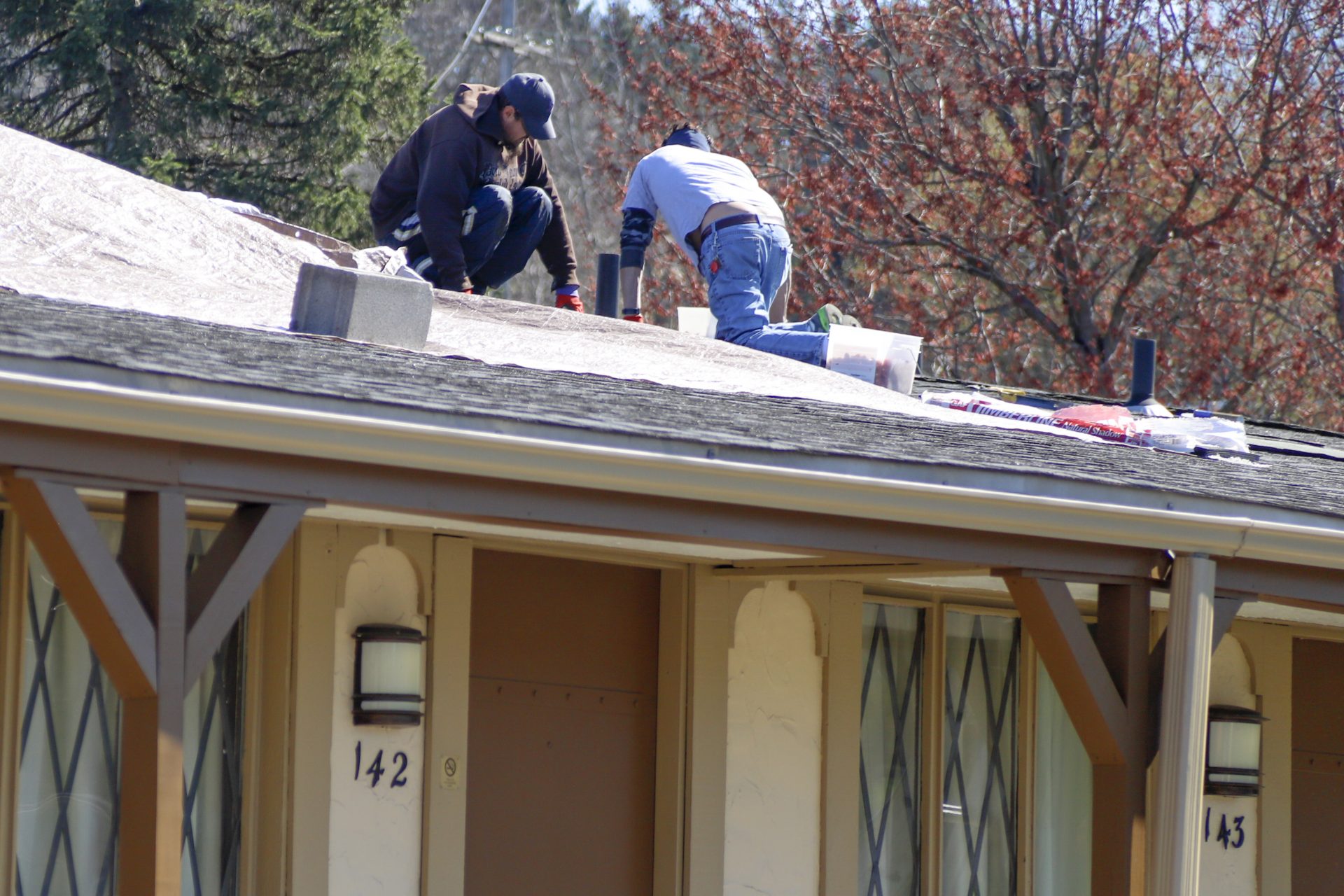 Roofers work on repairs at a motel in Greensburg, Pa. Thursday, April 2, 2020.