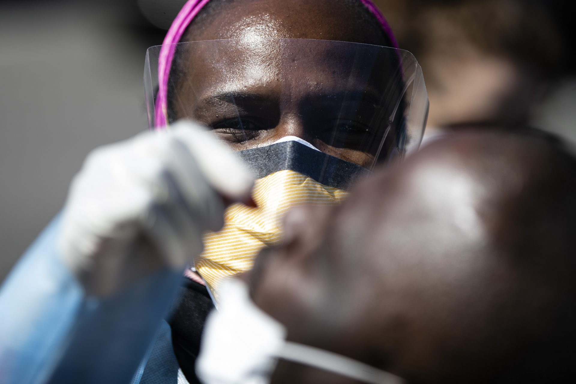 Dr. Ala Stanford administers a COVID-19 swab test on a person in the parking lot of Pinn Memorial Baptist Church in Philadelphia, Wednesday, April 22, 2020. Stanford and other doctors formed the Black Doctors COVID-19 Consortium to offer testing and help address heath disparities in the African American community.