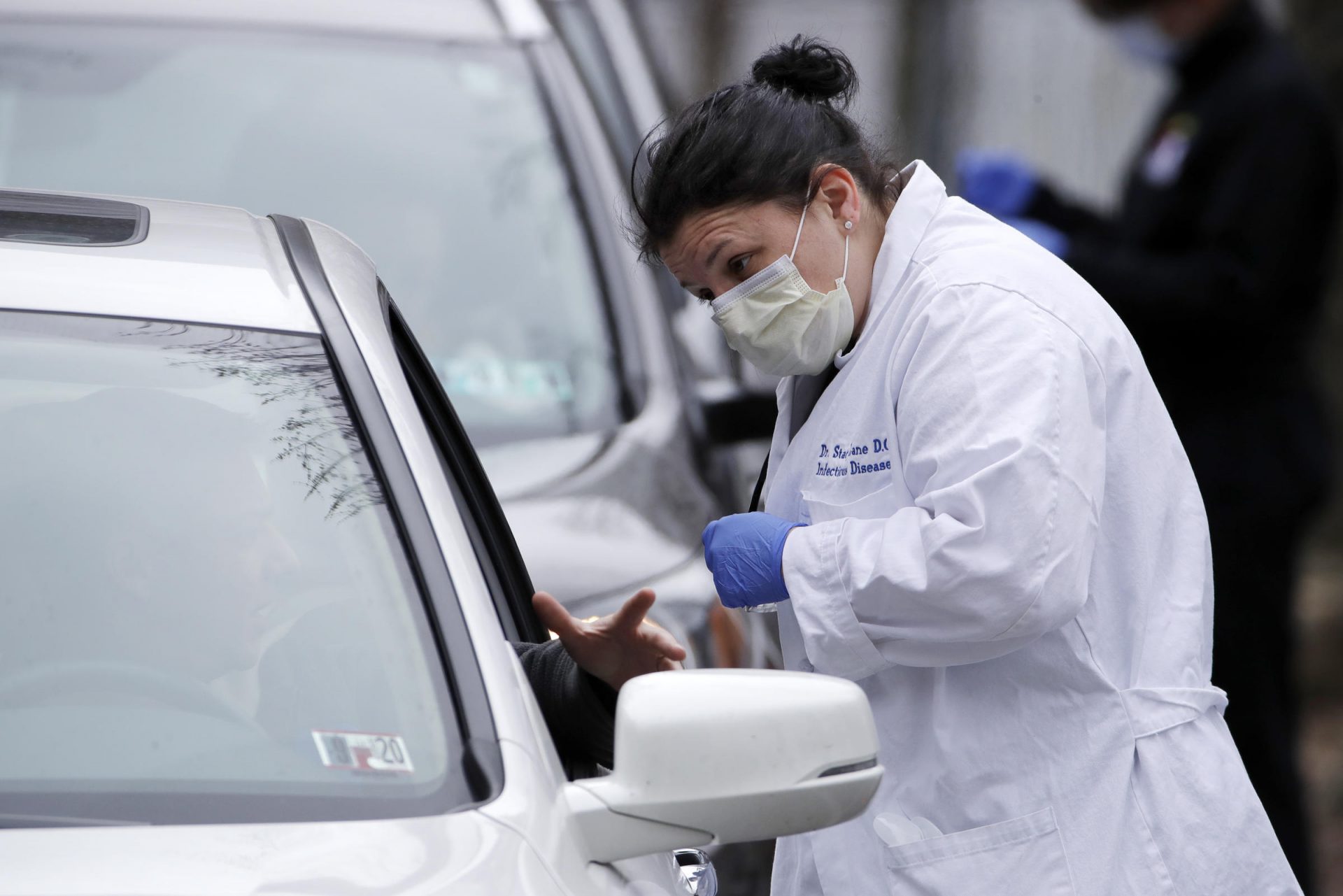 Cars line up outside the Central Outreach Wellness Center on the Northside of Pittsburgh Monday, March 16, 2020, for drive-by testing for COVID-19. The testing, that is limited to 100 kits at present, is being done in partnership with Quest Diagnostics, one of the commercial laboratory companies that have offered COVID-19 tests to dramatically increase the nation's capability. Central Outreach Medical Director Dr. Stacy Lane said the drive-by testing is being used to not contaminate waiting rooms. The testing is based on screening questions for symptoms of dry cough or fever, Central Outreach said.