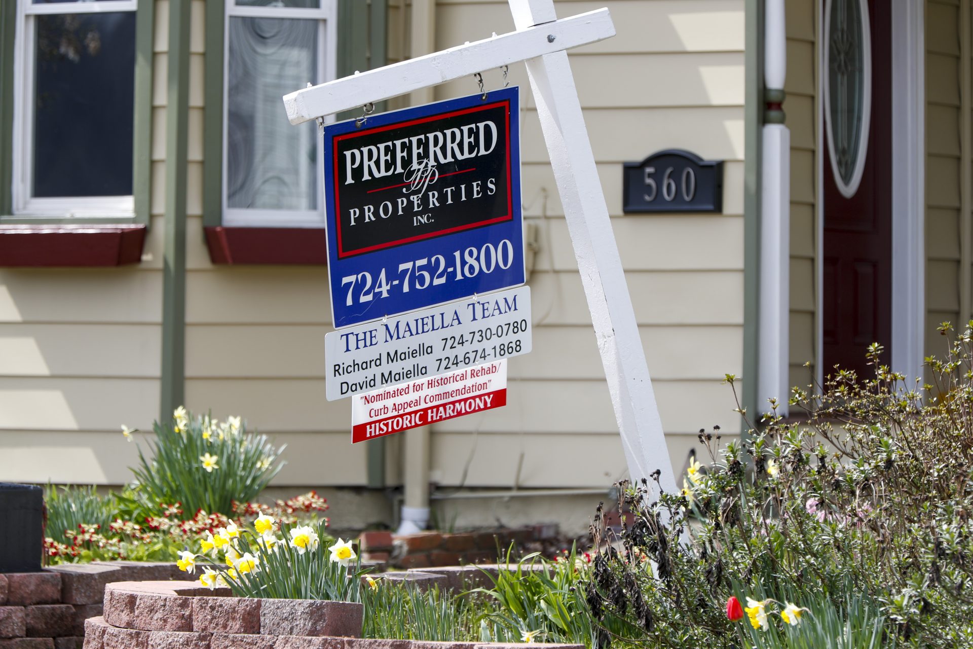 A real estate company sign marks a home for sale, Thursday, April 16, 2020, in Harmony, Pa.