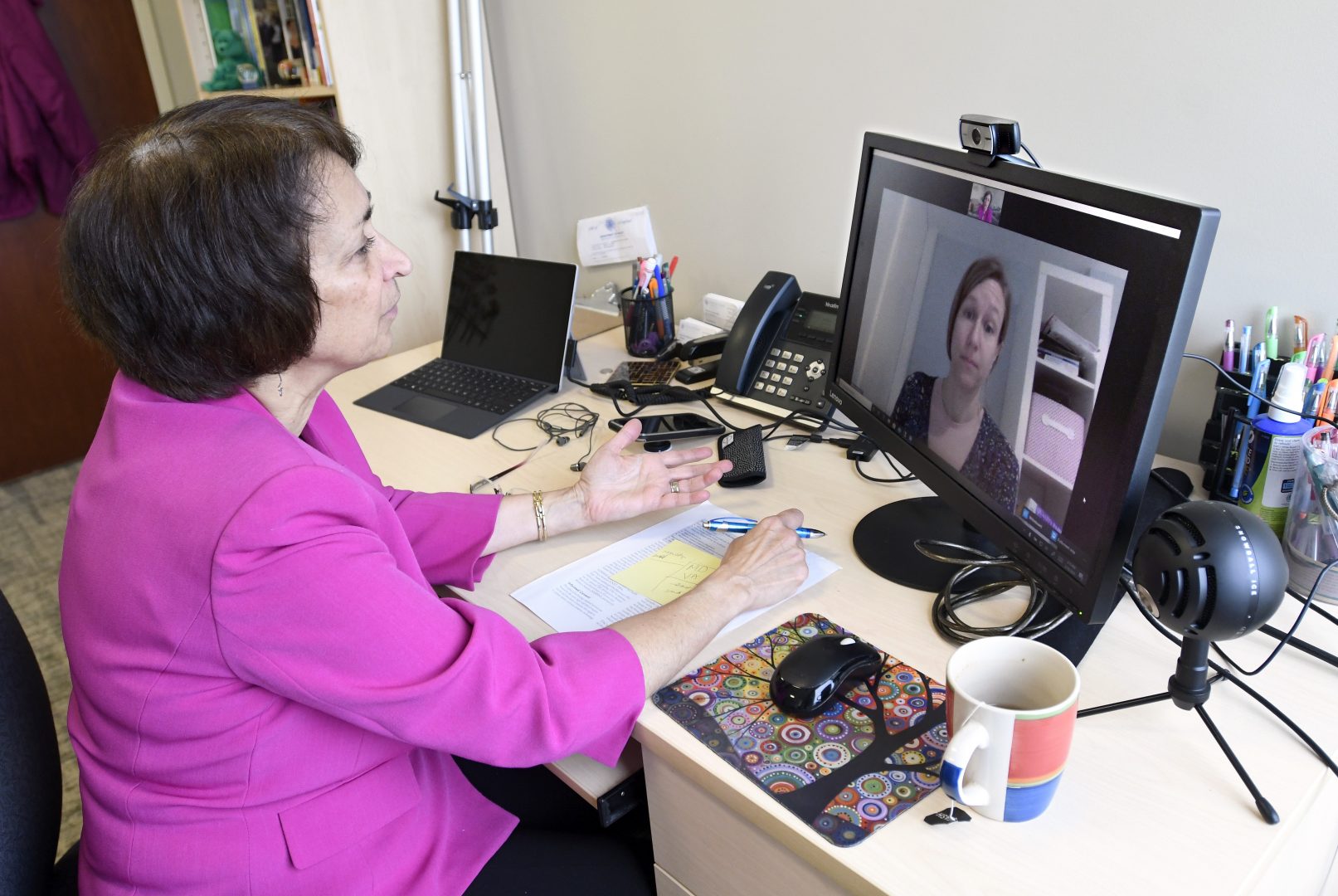 Psychologist Mary Alvord, left, holds a video conference with her colleague, psychologist Veronica Raggi, whom she had scheduled to meet in person, in Chevy Chase, Md., Wednesday, March 18, 2020. For people with anxiety disorders, the coronavirus outbreak presents a new set of worries to deal with, psychologists say.