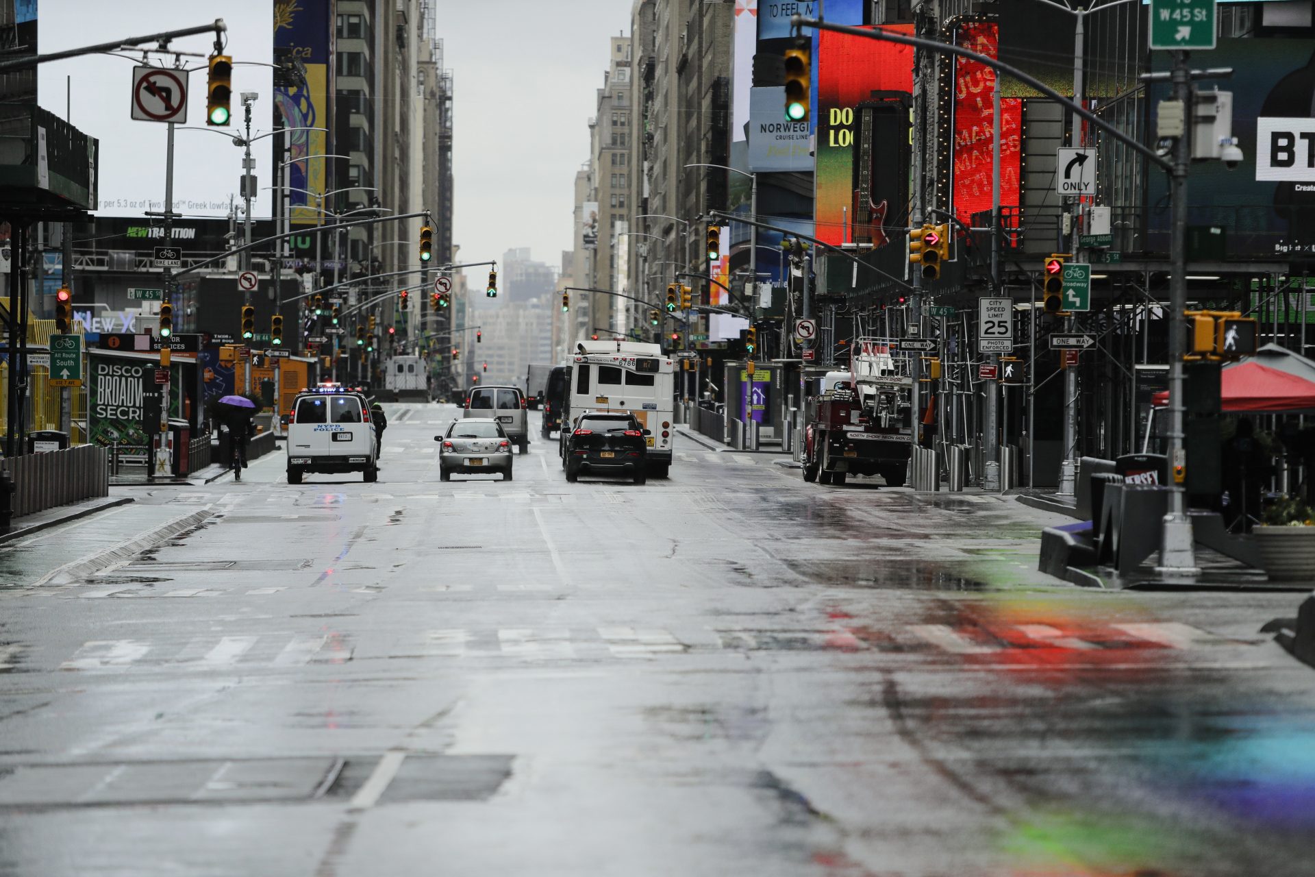 Cars drive down a mostly empty Seventh Avenue during the coronavirus outbreak Friday, April 3, 2020, in New York's Times Square. The new coronavirus causes mild or moderate symptoms for most people, but for some, especially older adults and people with existing health problems, it can cause more severe illness or death.