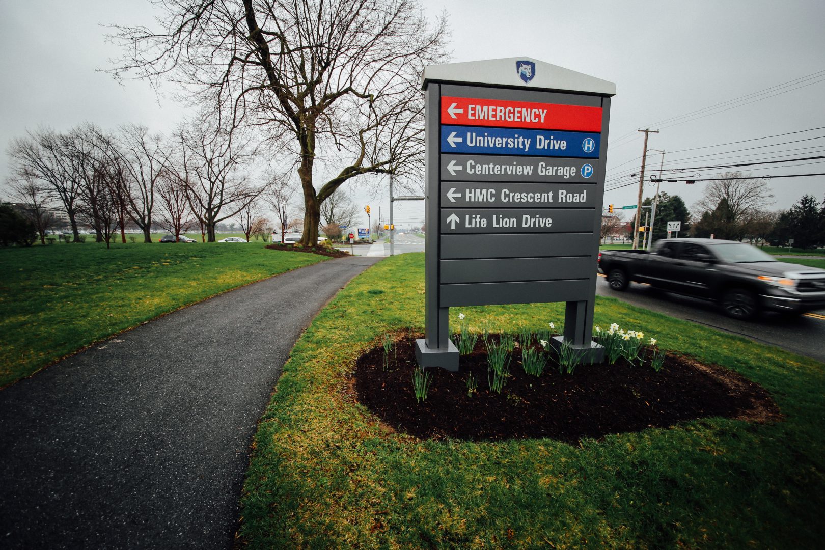 FILE PHOTO: A car passes by a sign at Penn State Health's Milton S. Hershey Medical Center on April 1, 2020.