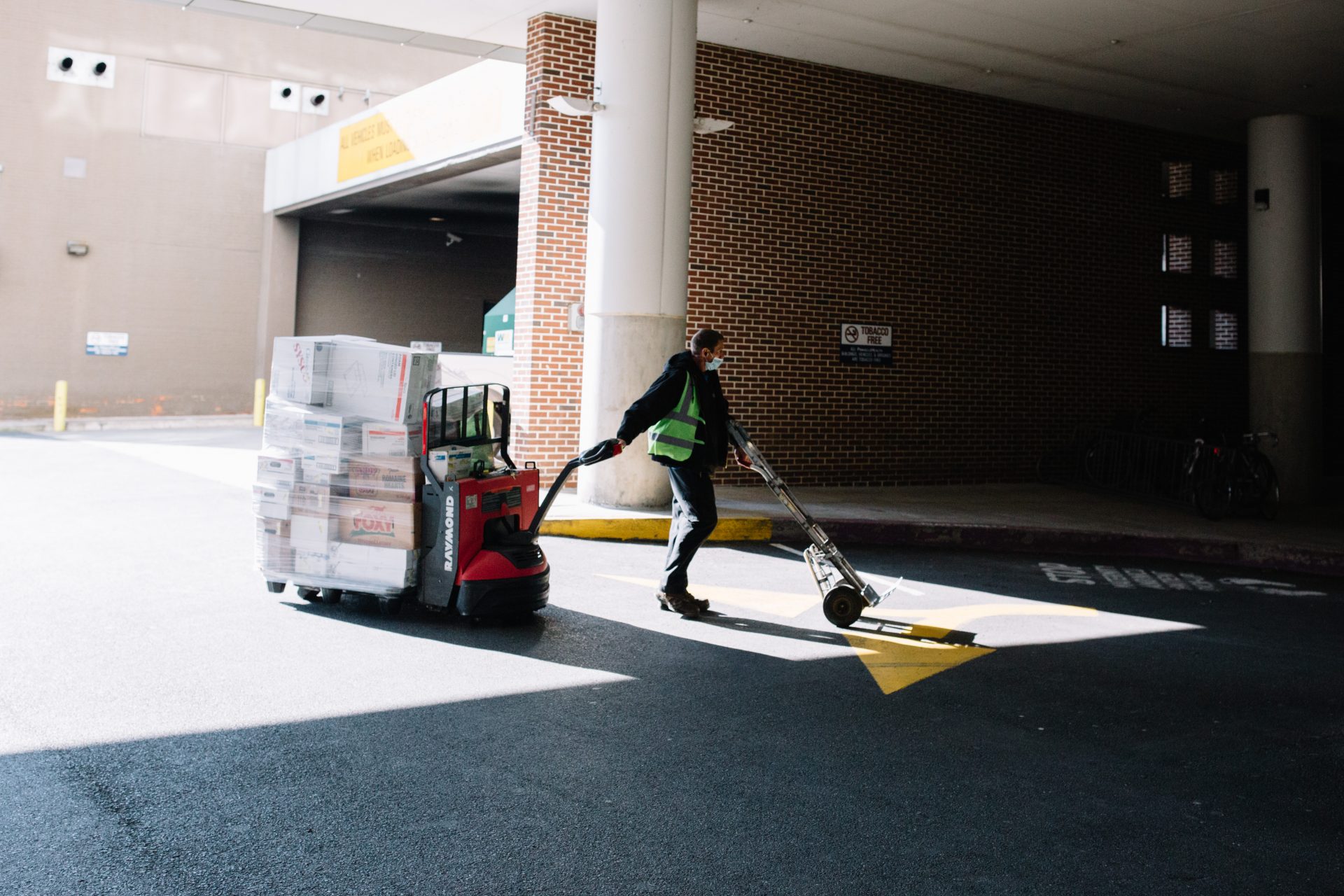 A worker hauls boxes while wearing a mask in Harrisburg on April 10, 2020.