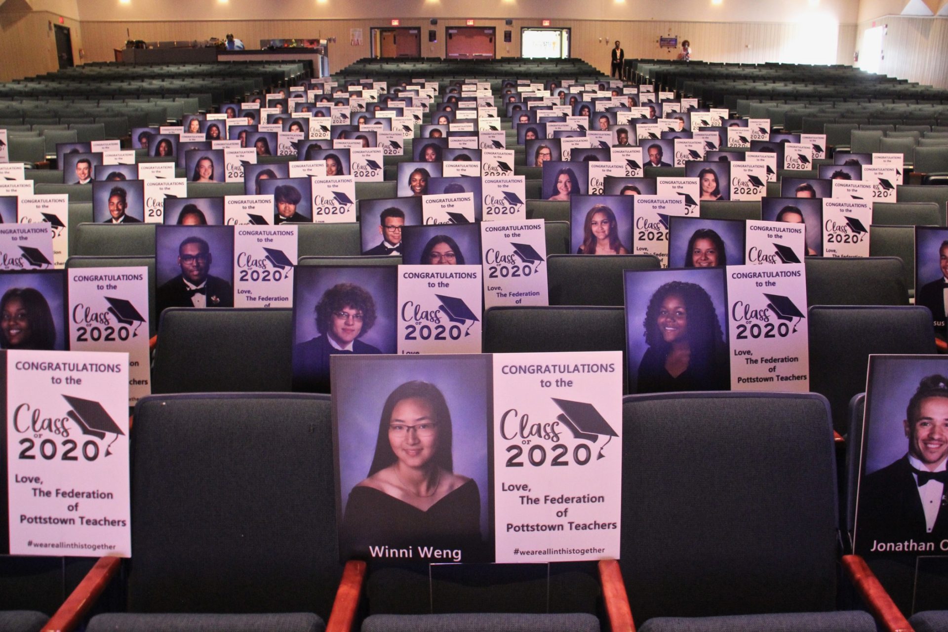 Pottstown High School seniors graduate one at a time before an audience of lawn signs representing their classmates. The ceremony will take six days. (Emma Lee/WHYY)