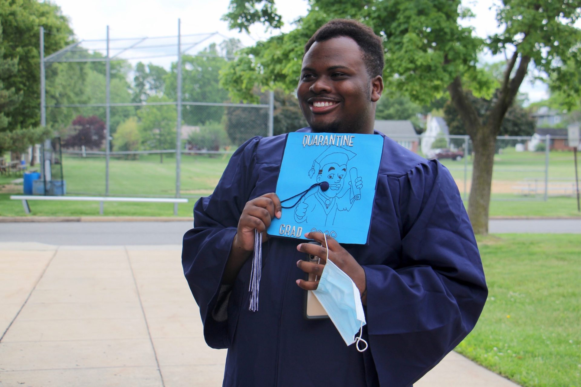 Pottstown High School graduate Sensair Wesley decorated his mortarboard with a self portrait. (Emma Lee/WHYY)