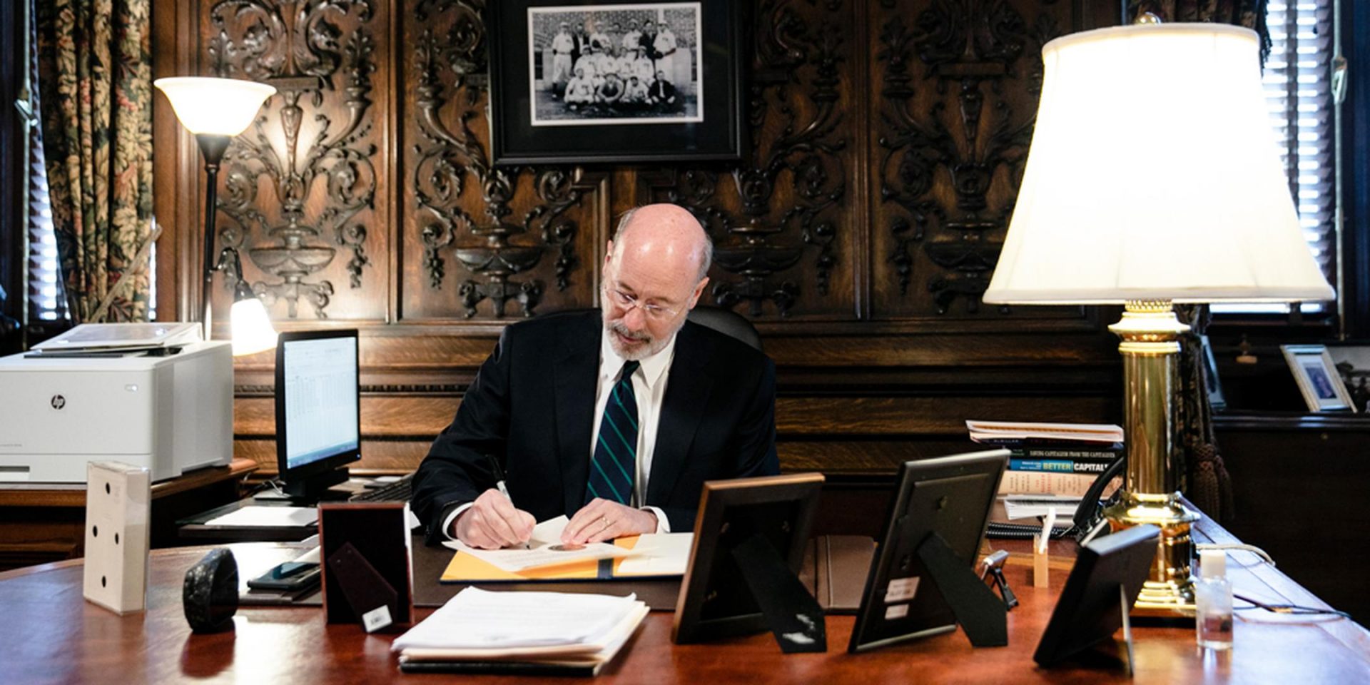 A file photo from March 2020 of Gov. Tom Wolf signing the coronavirus disaster declaration for the state.