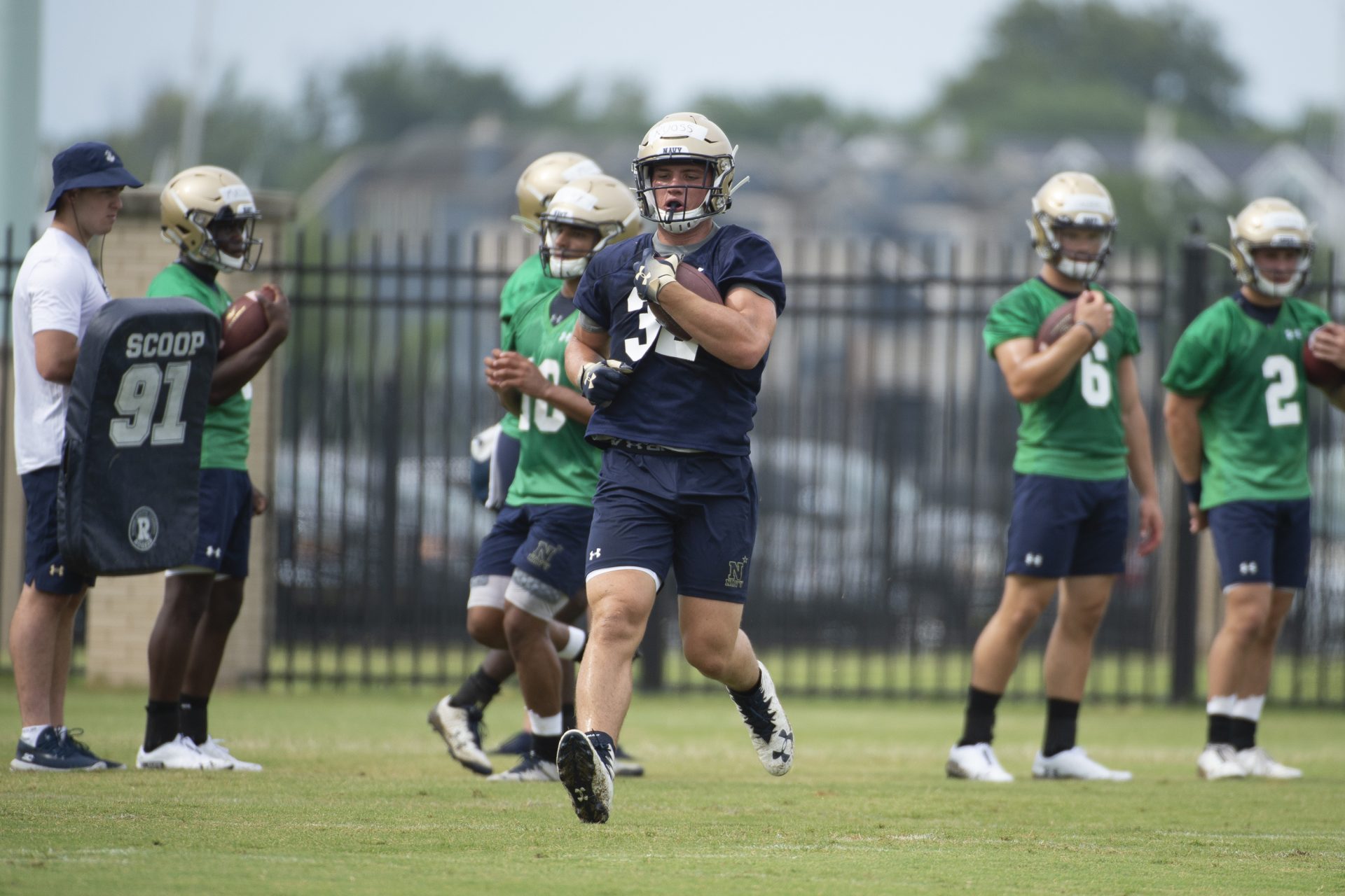 Navy fullback Isaac Ruoss runs with the ball during morning workouts NCAA college football training camp, Friday, Aug. 2, 2019, in Annapolis, Md.