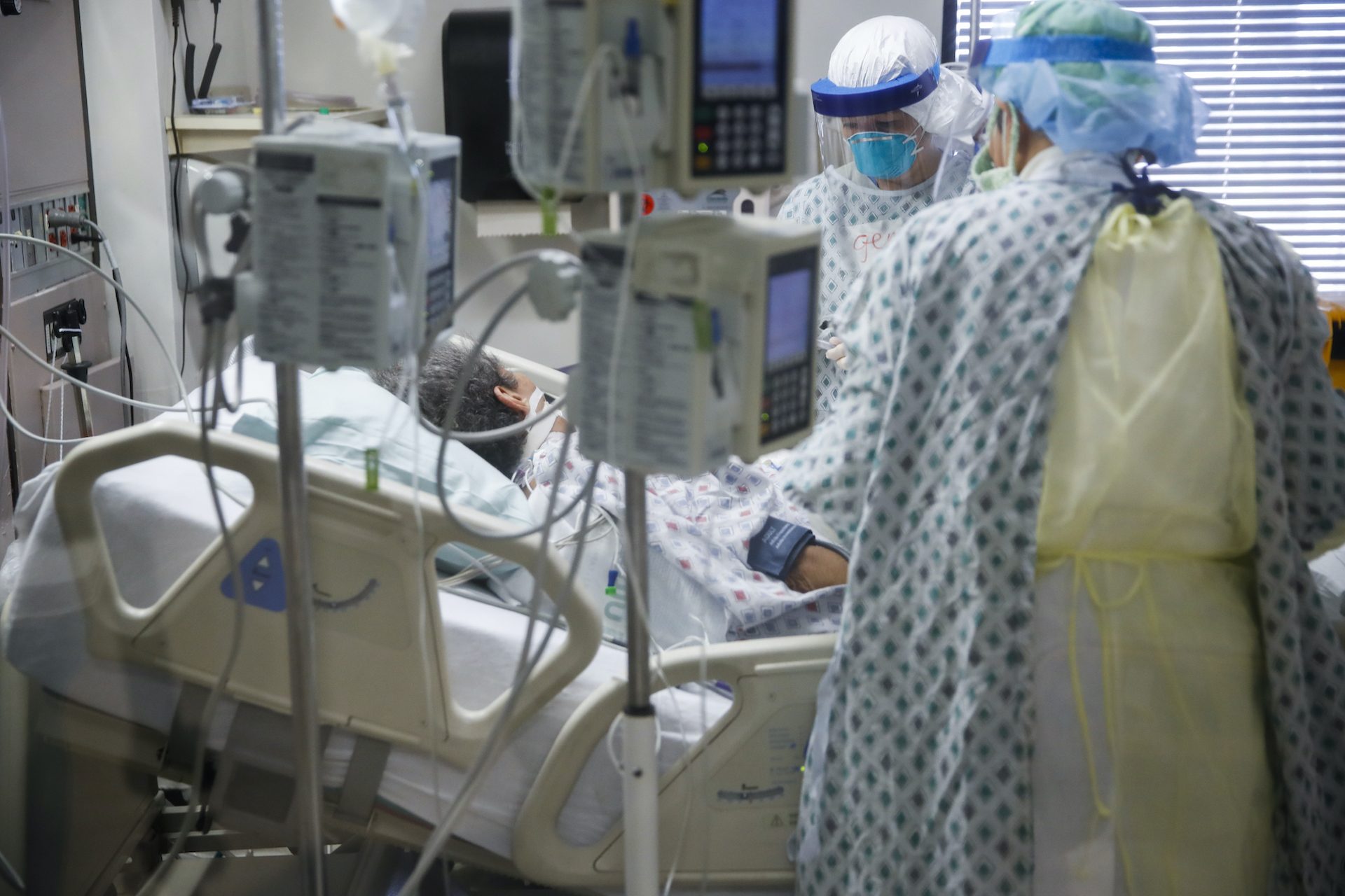 Intensive care unit staff members care for a COVID-19 patient, Monday, April 20, 2020, at St. Joseph's Hospital in Yonkers, N.Y.