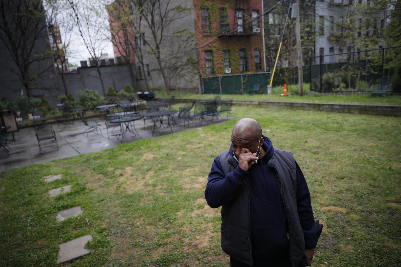 Milton I., 50, a resident living with schizophrenia at The Robert Meineker House, wipes his eyes as he speaks about the loneliness caused by social distancing in an empty common area, Wednesday, May 6, 2020, in the Brooklyn borough of New York. Even before the pandemic, access to mental health services in the U.S. could be difficult, including for people with insurance. Now experts fear COVID-19 will make the situation worse.