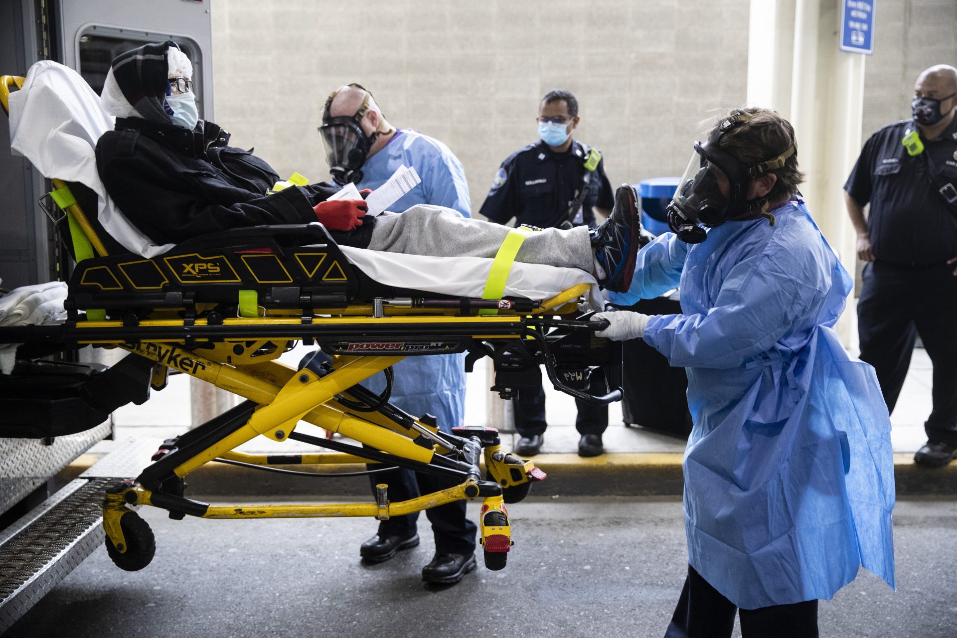 Paramedics load a person who has been staying overnight at Philadelphia International Airport into an ambulance in Philadelphia, Tuesday, May 26, 2020. Officials on Tuesday began removing dozens of people who have been sleeping at the city's airport during the coronavirus pandemic.