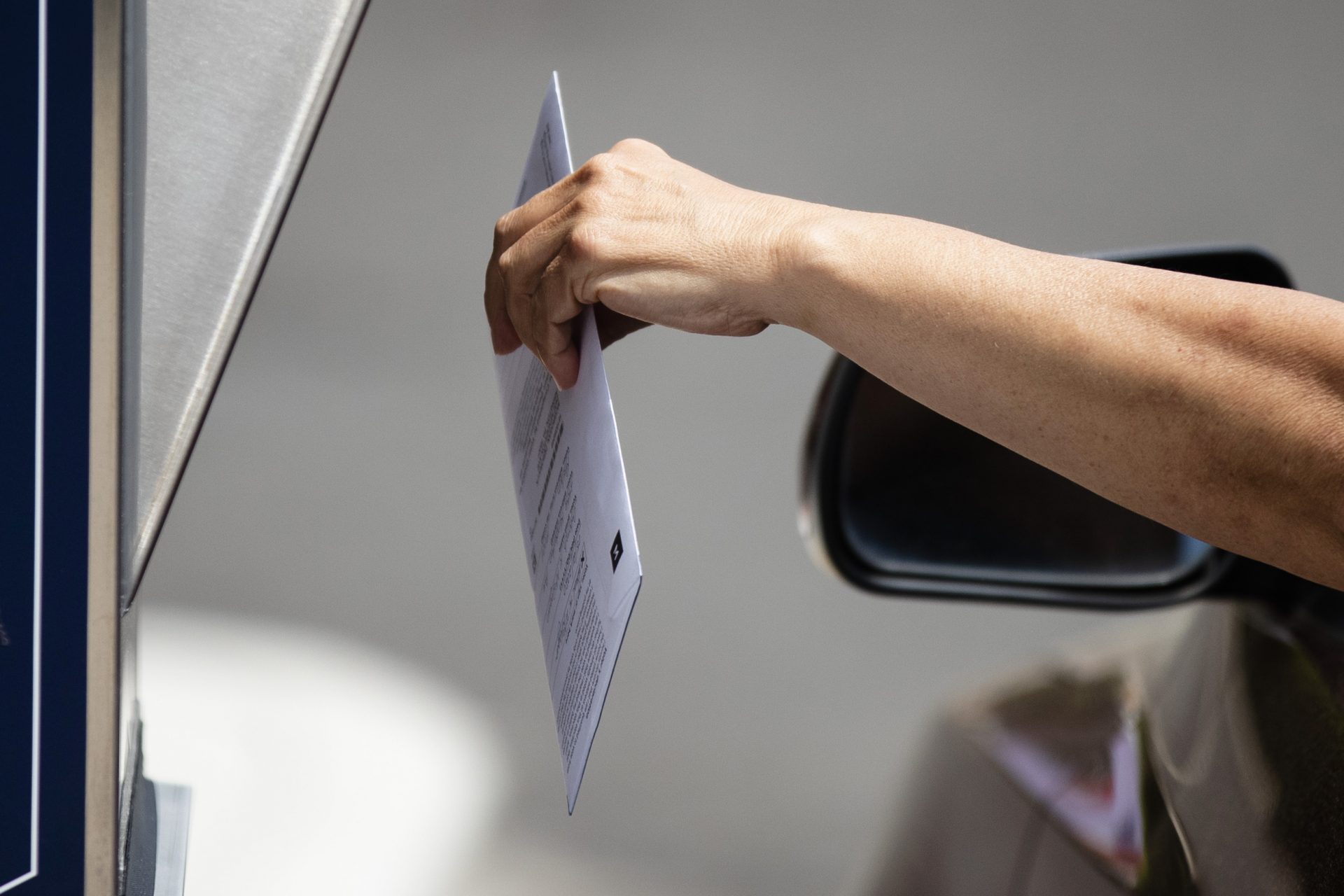 A voter drops off their mail-in ballot prior to the primary election, in Willow Grove, Pa., Wednesday, May 27, 2020.