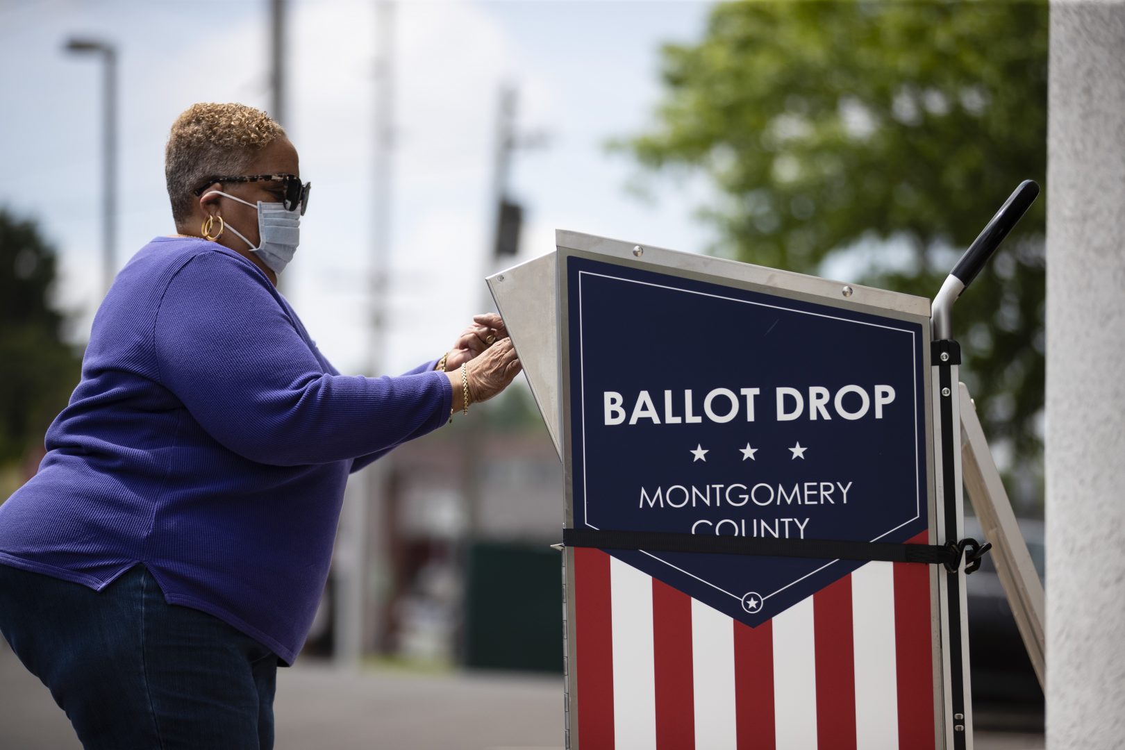 A voter drops off their mail-in ballot prior to the primary election, in Willow Grove, Pa., Wednesday, May 27, 2020.