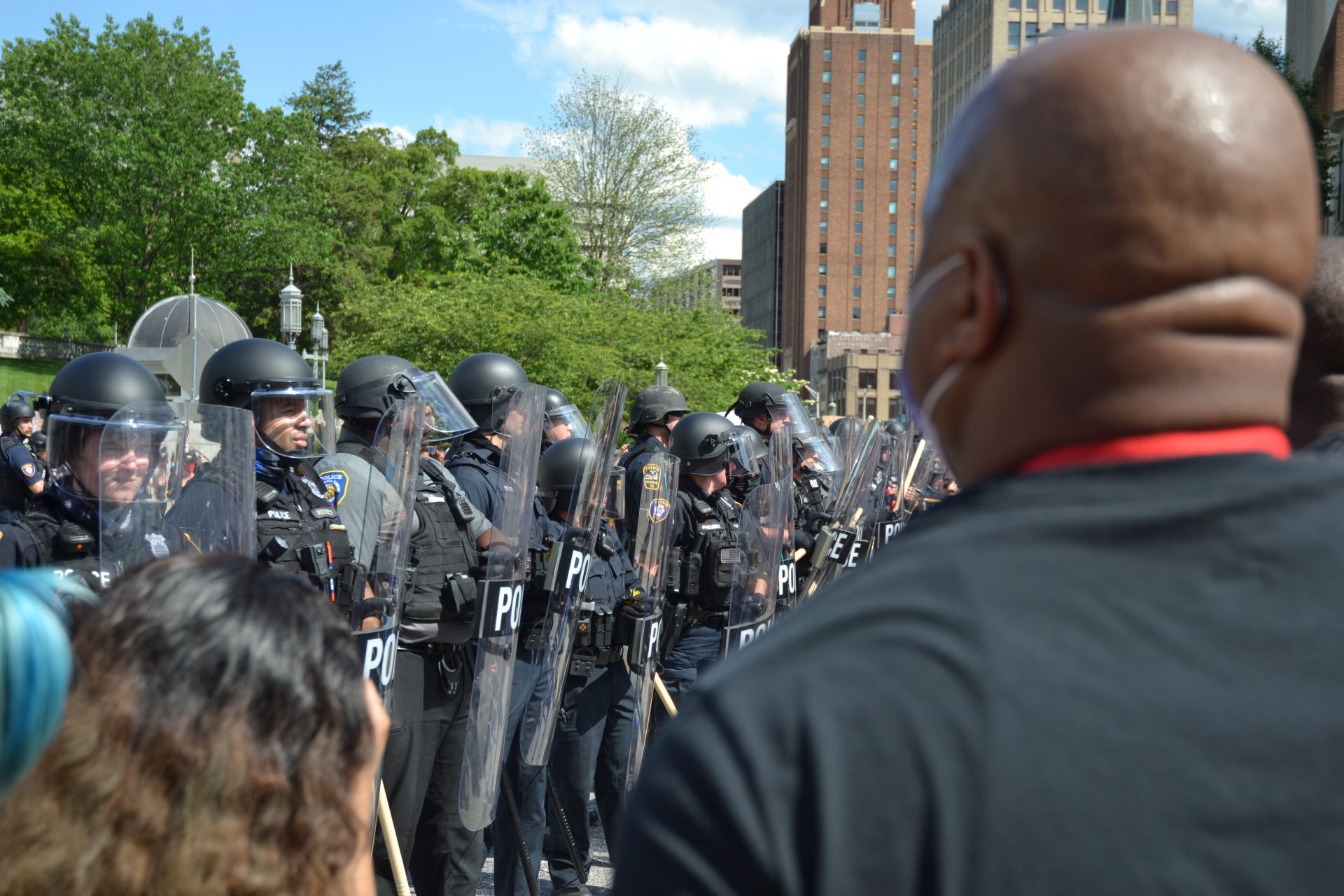 A protester stands in front of police in riot gear in Harrisburg Sat., May 30, 2020.