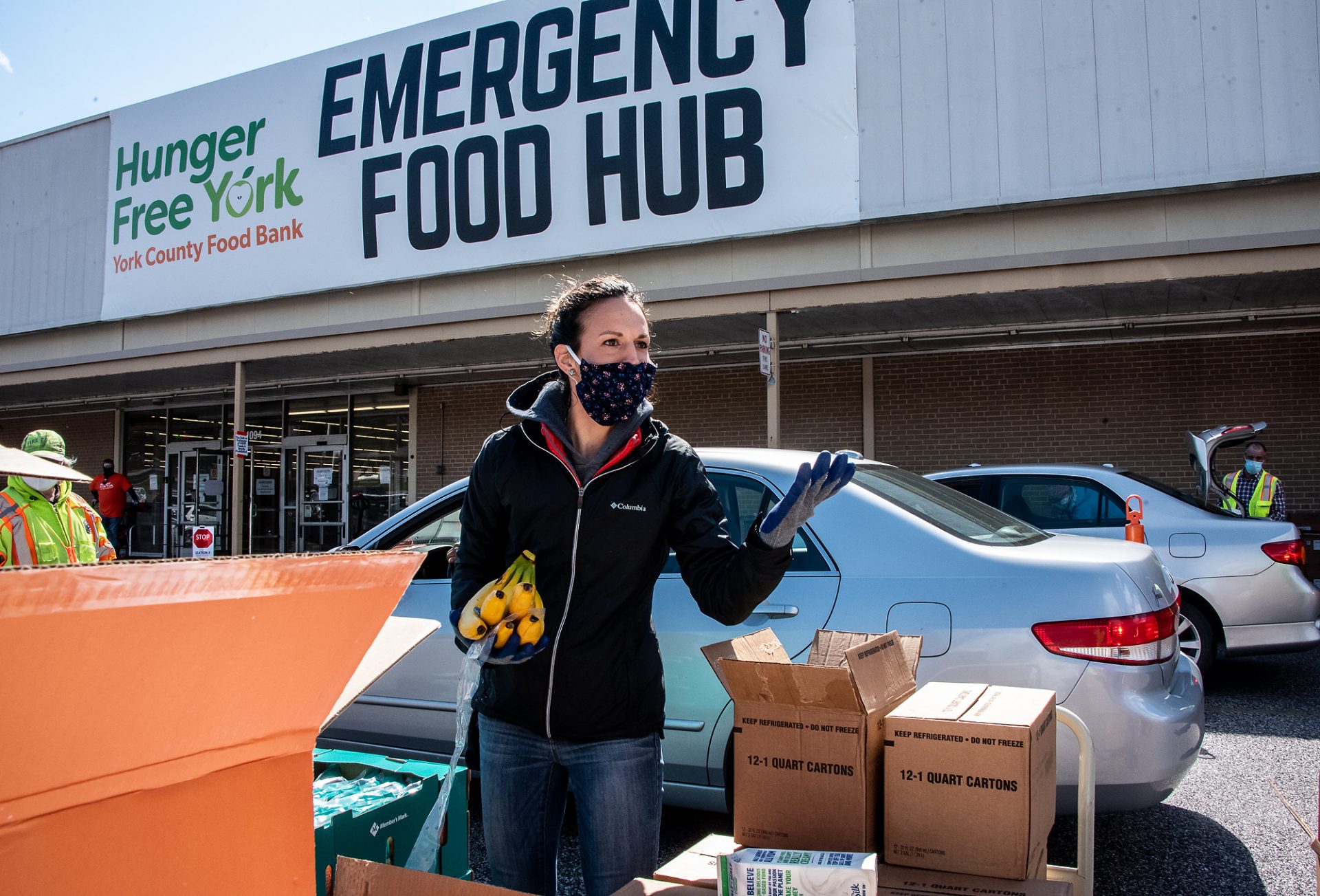 A volunteer helps prepare food boxes at a distribution event in York County.