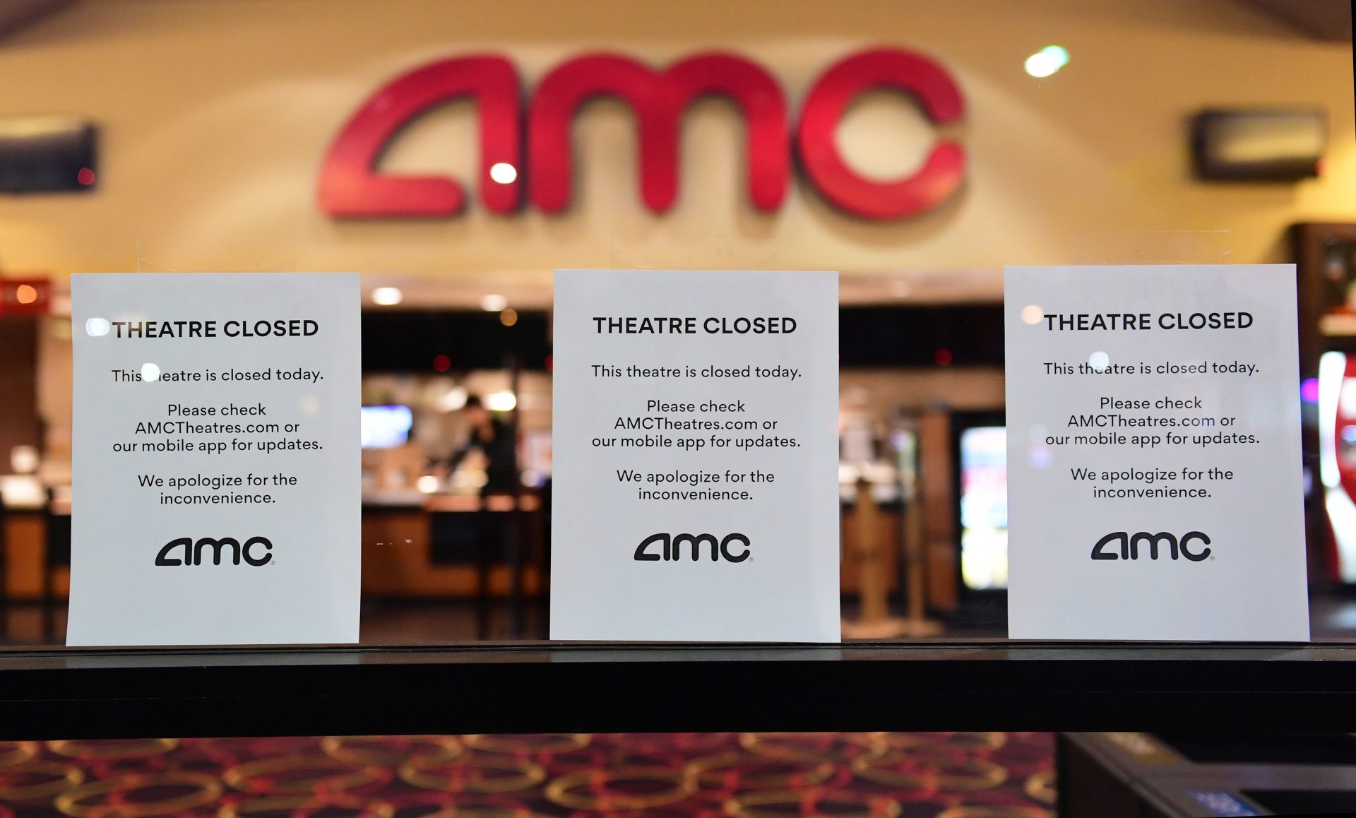 None of the three major national theater chains — AMC Theatres, Regal Cinemas and Cinemark — have plans to reopen before June. Above, signs are posted in front of the AMC in Montebello, Calif., on March 17, 2020.