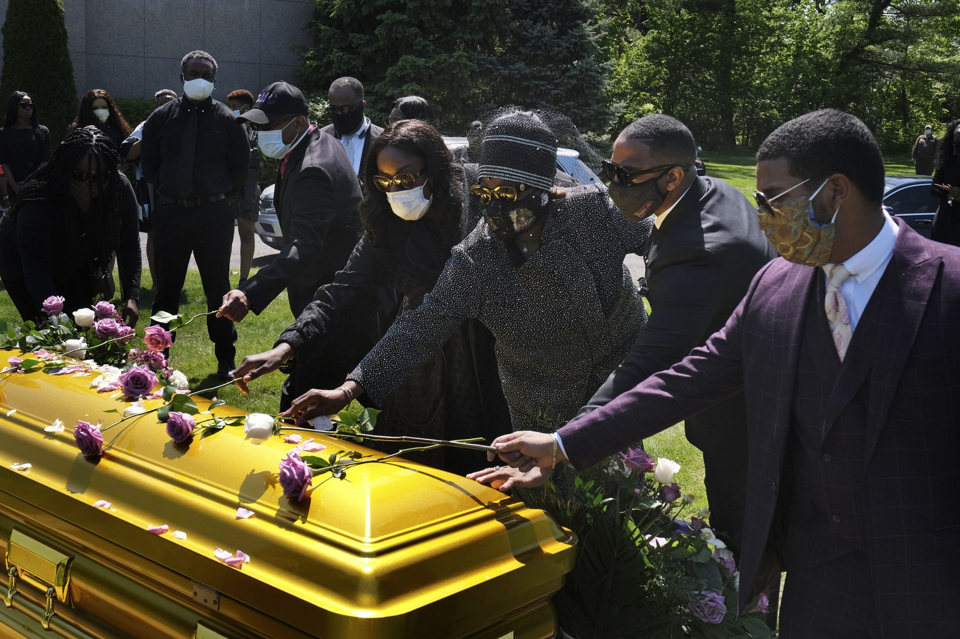 Family and friends lay flowers on the casket of Bishop Carl Williams Jr. last week at Hollywood Memorial Park and Cemetery in Union, N.J. Only a few family members were permitted to attend the service in person due to the pandemic.