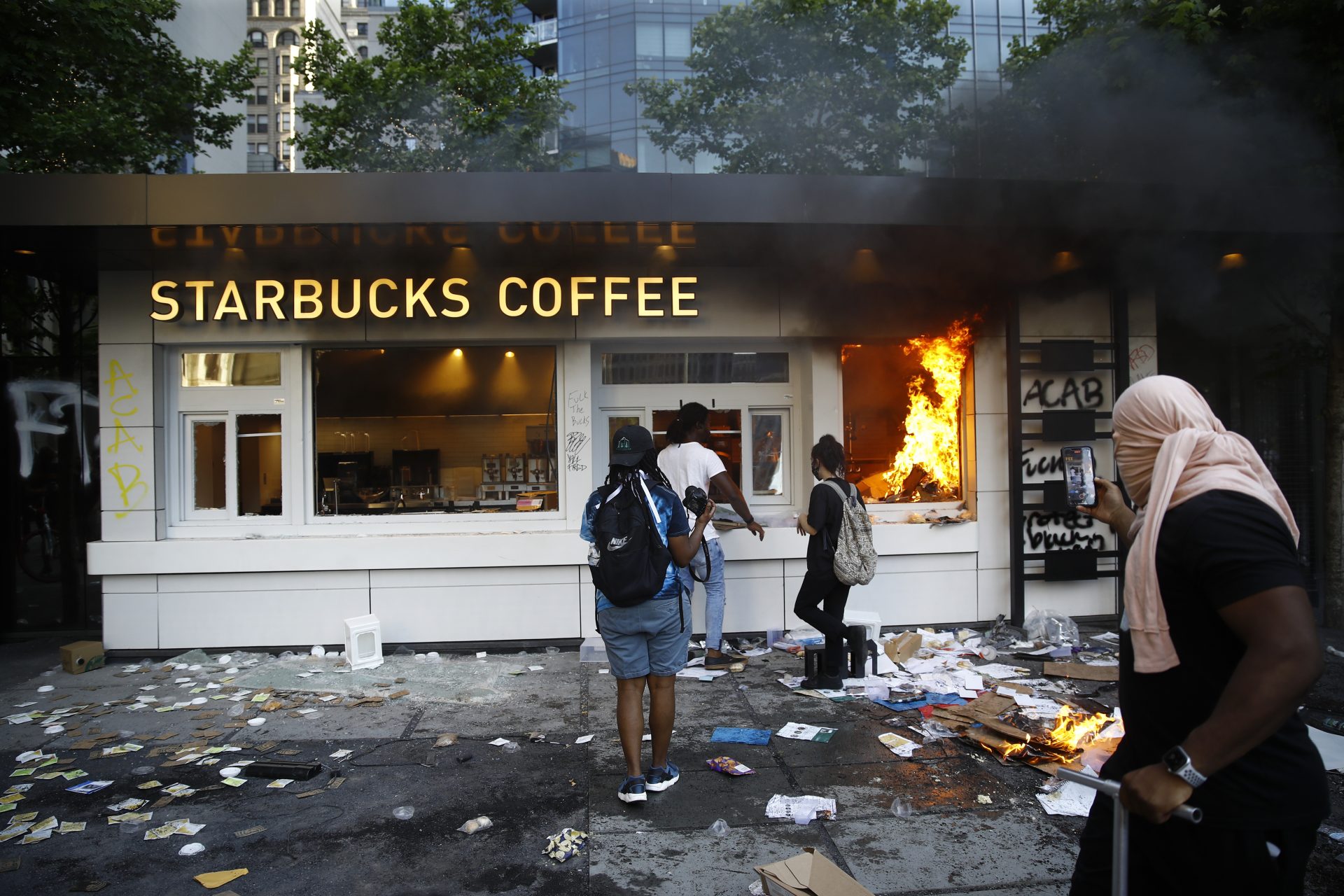A Starbucks store burns during a protest on Saturday, May 30, 2020, in Philadelphia, over the death of George Floyd, a black man who died after being taken into police custody in Minneapolis. Floyd died after an officer pressed his knee into his neck for several minutes even after he stopped moving and pleading for air on Memorial Day.