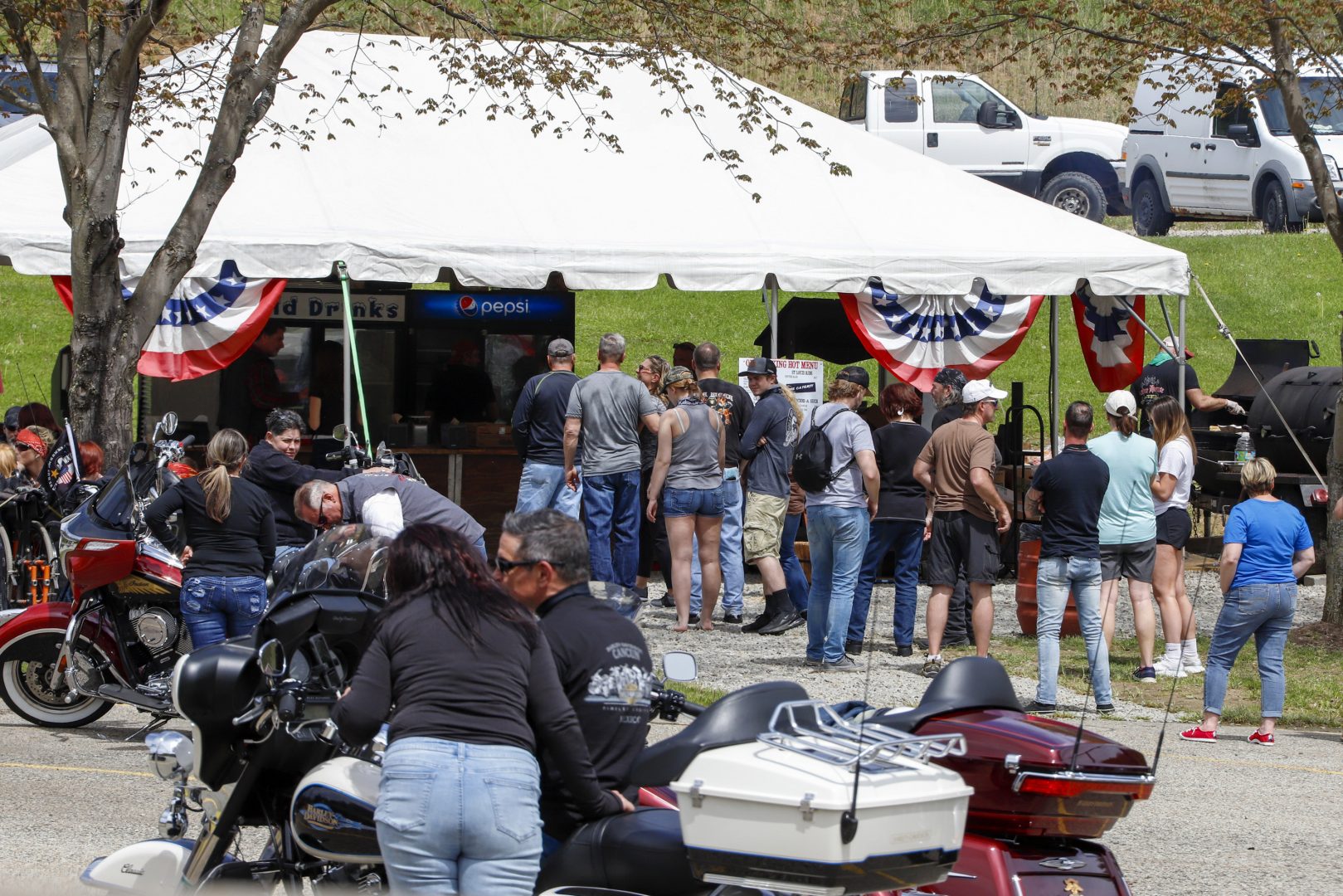 A crowd waits for barbecue in the parking lot of the historic Stonehouse Inn in Farmington, Pa, Saturday, May 16, 2020. 