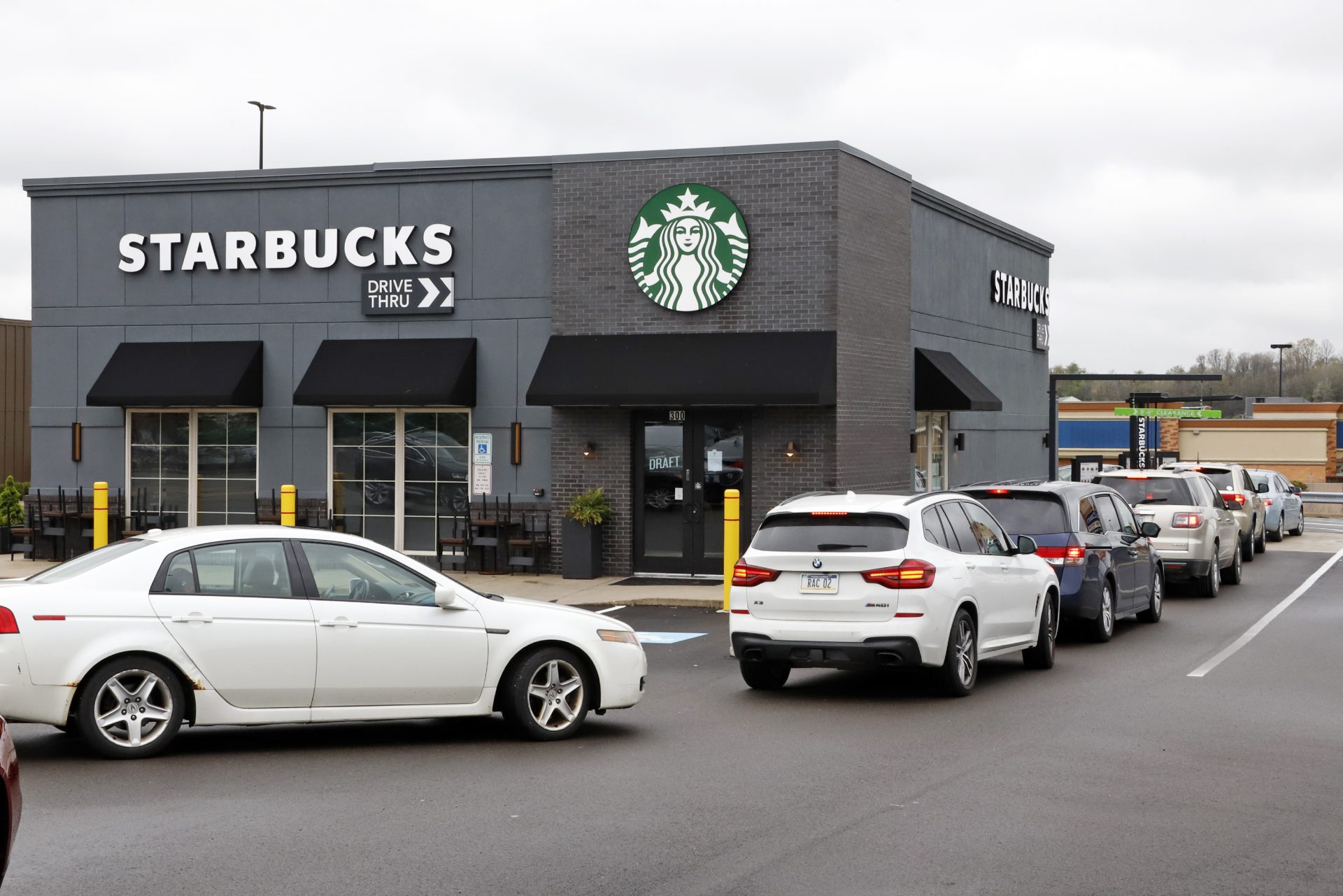 Cars line up in the drive-thru of a Starbucks in Robinson Township, Pa., Wednesday, May 6, 2020.