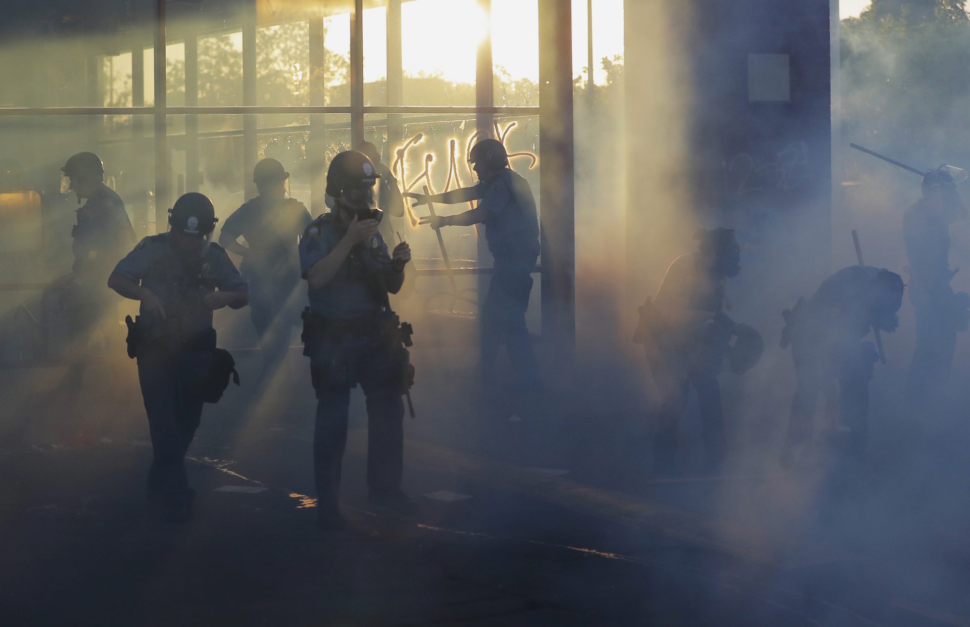 Police move through an area during demonstrations Thursday, May 28, 2020, in St. Paul, Minn. Protests over the death of George Floyd, the black man who died in police custody broke out in Minneapolis for a third straight night.