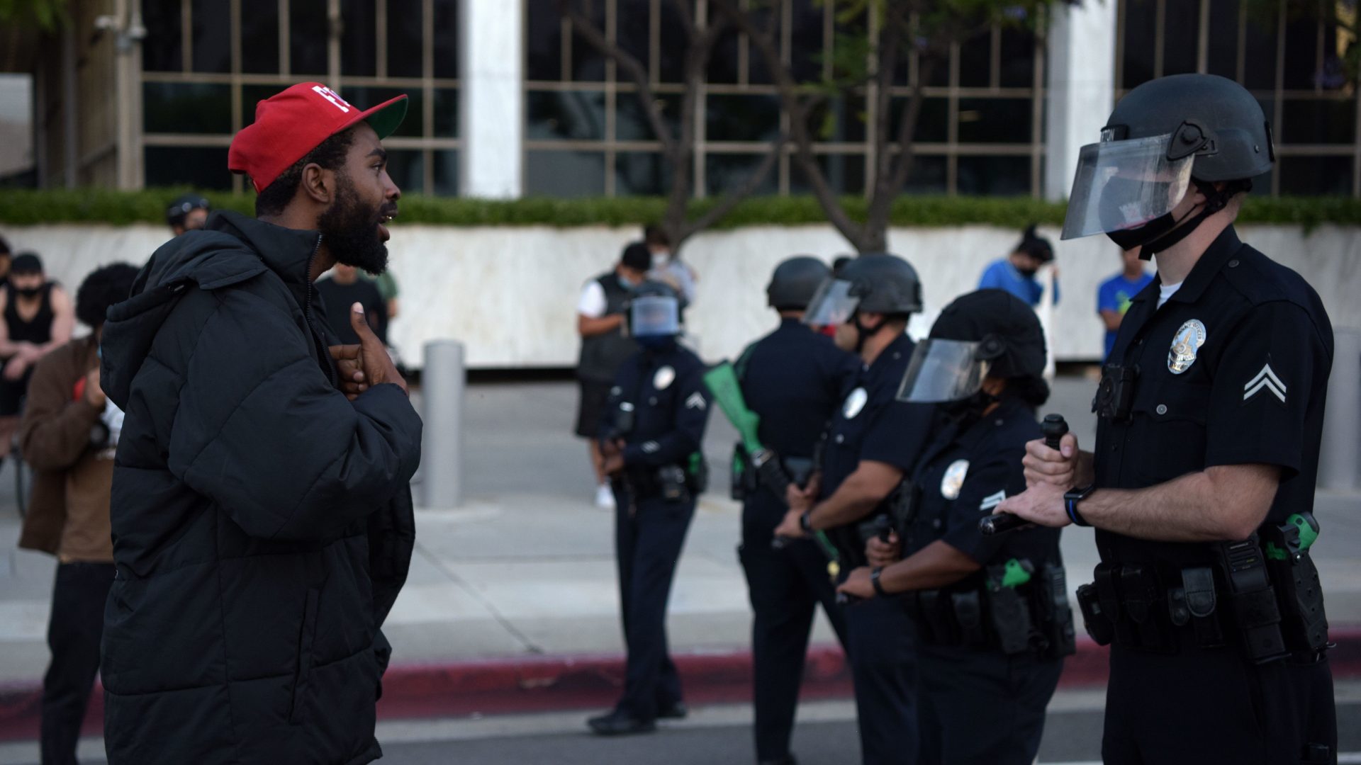 A demonstrator explains himself to an officer in riot gear during a protest Wednesday in downtown Los Angeles. The impact of George Floyd's death has been felt well beyond Minneapolis' city limits.