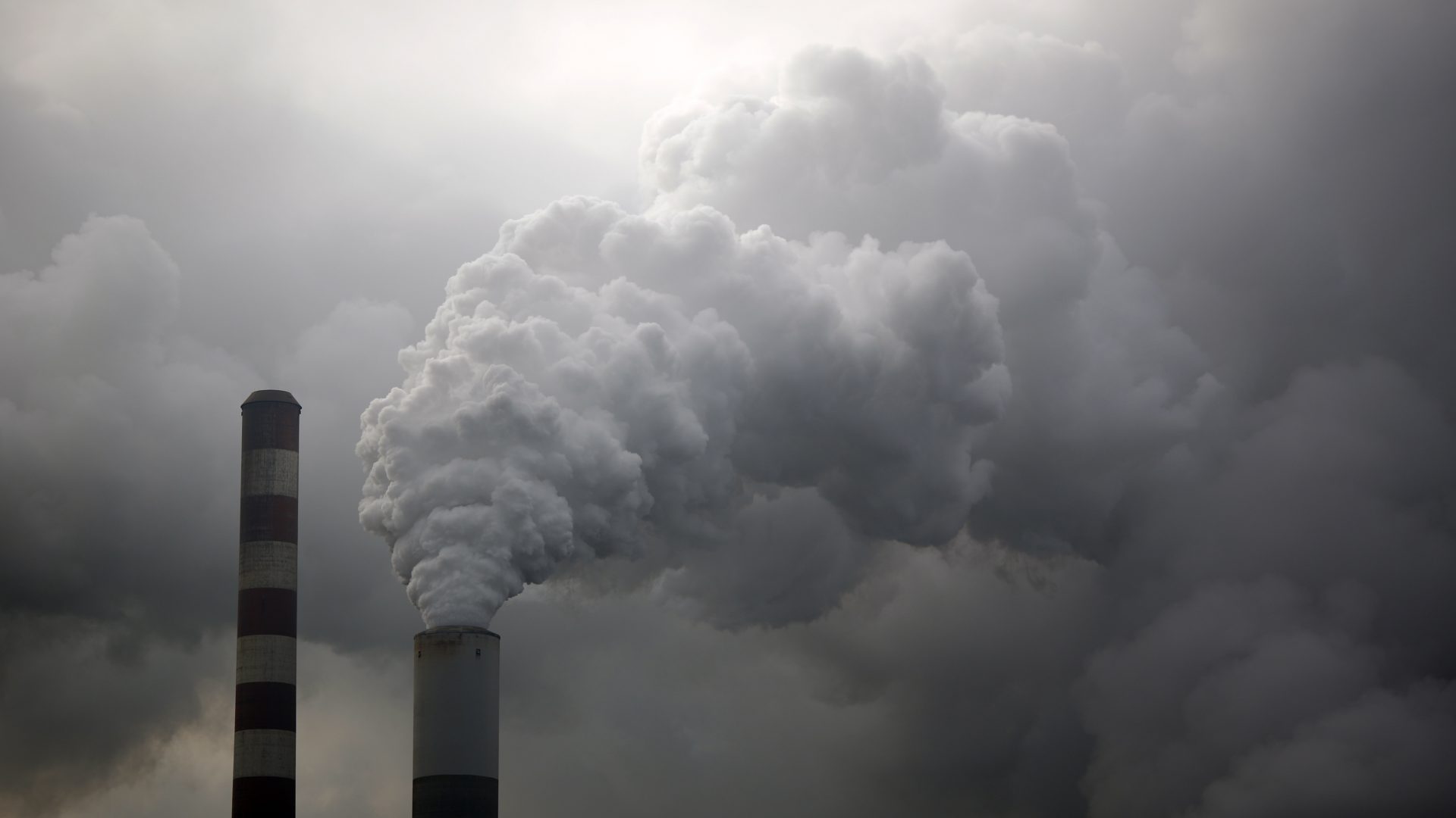 Water vapor rises from a coal powered power plant stack. Pollution from burning coal affects a larger area than vehicle emissions.