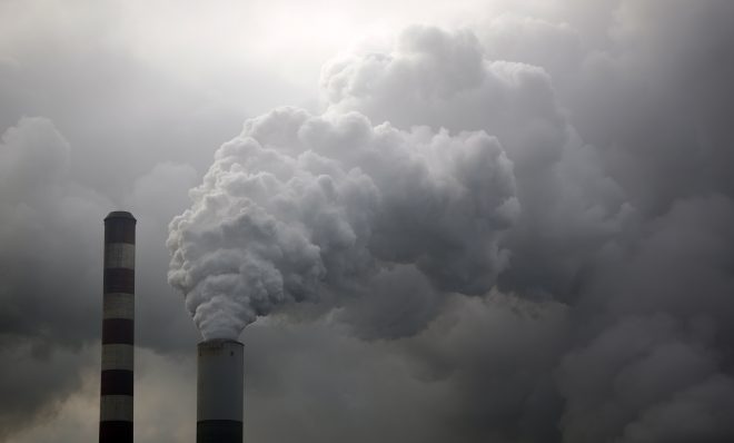 Water vapor rises from a coal powered power plant stack. Pollution from burning coal affects a larger area than vehicle emissions.