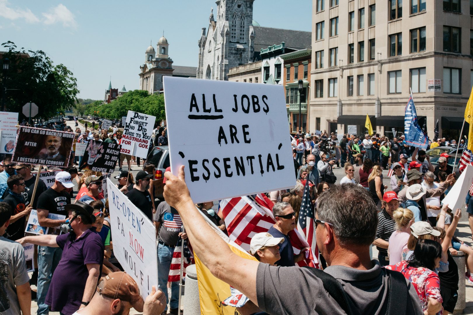 FILE PHOTO: Protesters hold signs during a May 15, 2020, rally outside the state capitol in Harrisburg, Pa. About 1,000 people showed up to protest Gov. Wolf's coronavirus shutdown order.
