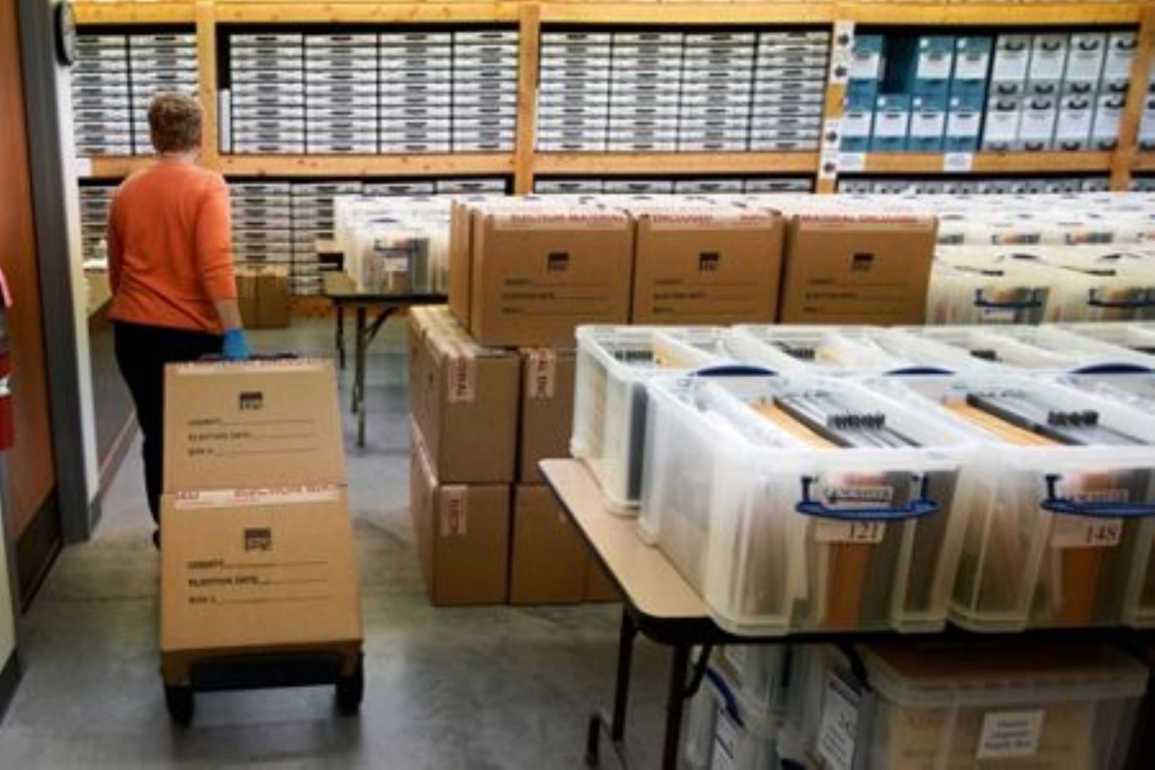  Nadette Cheney wheels in boxes of printed ballots at the Lancaster County Election Committee offices in Lincoln, Neb., April 14, 2020.