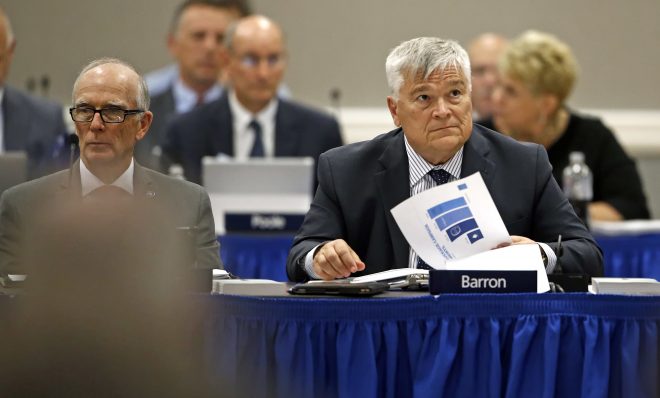 FILE PHOTO: Penn State President Eric J. Barron, right, listens during a Penn State University Board of Trustees meeting on the campus of Penn State Harrisburg in Middletown, Pa., Friday, July 21, 2017. 