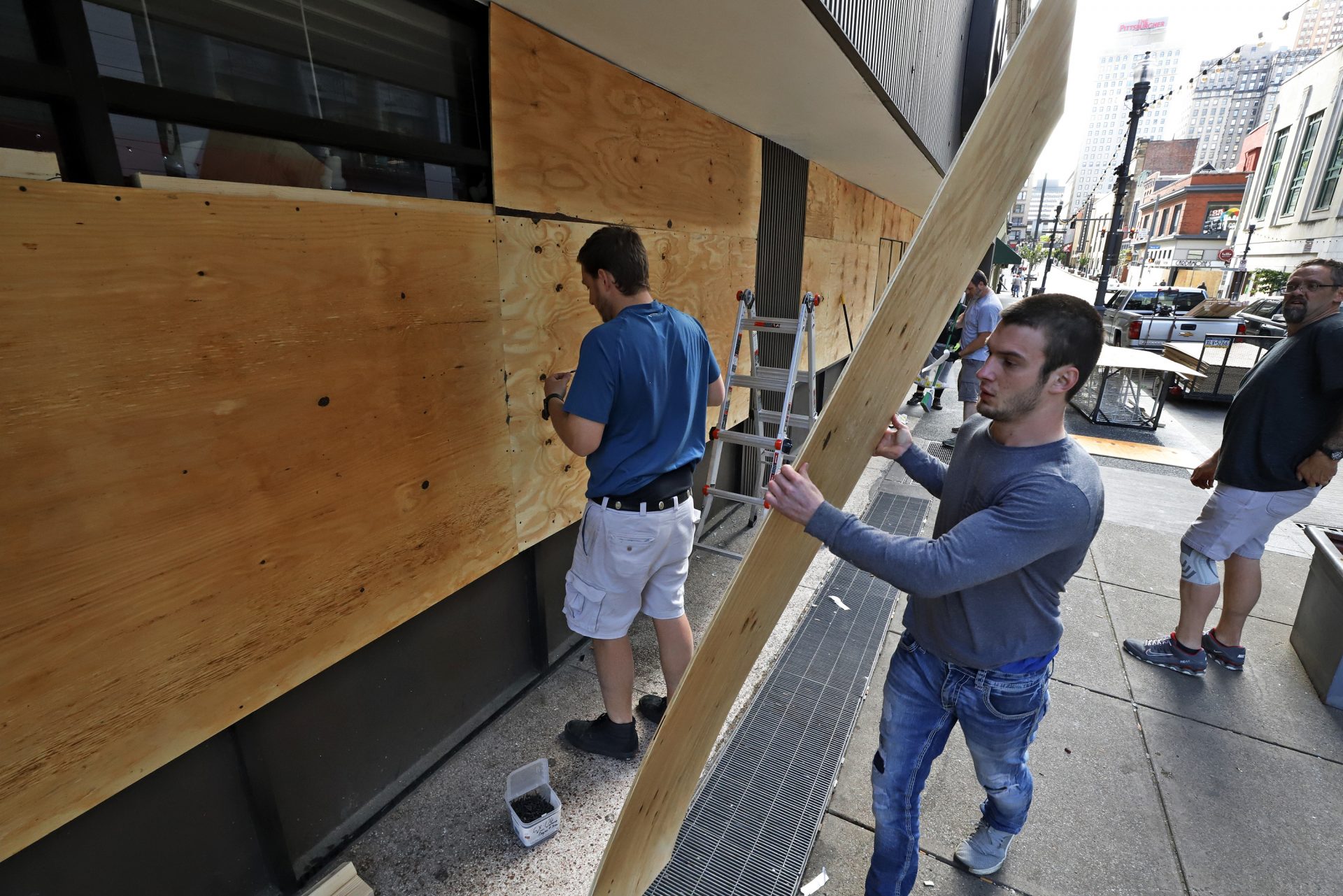 Windows broken in a downtown Pittsburgh CVS Pharmacy are repaired Sunday, May 31, 2020. The damage was done a during a march in Pittsburgh, Saturday, May 30, 2020 to protest the death of George Floyd, who died after being restrained by Minneapolis police officers on Memorial Day, May 25.