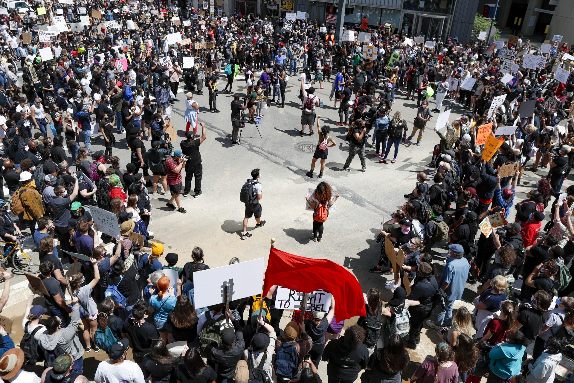 Demonstrators stop at an intersection during a march in Pittsburgh, Saturday, May 30, 2020 to protest the death of George Floyd, who died after being restrained by Minneapolis police officers on Memorial Day, May 25