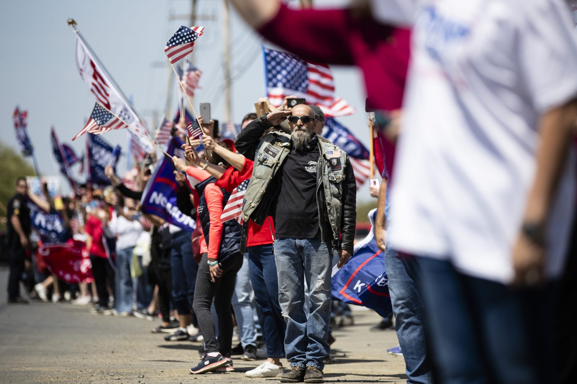 A man salutes as President Donald Trump's motorcade drives past on Thursday, May 14, 2020, in Allentown, Pa.