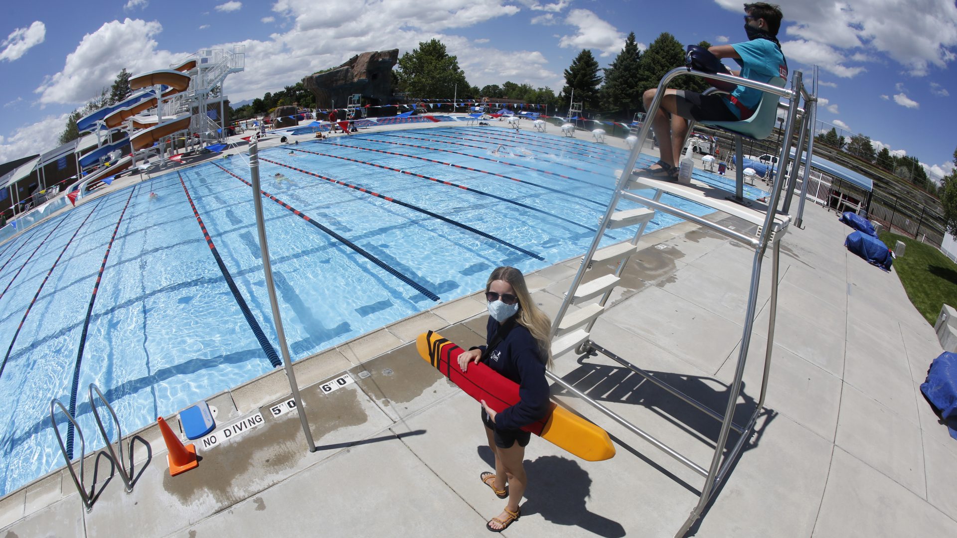 Life guards wear masks by the swimming pool at the Cottonwood Heights Recreation Center Thursday, May 21, 2020, in Murray, Utah. As most of Utah moves to 'yellow' safety level, signs of normalcy begin to emerge.