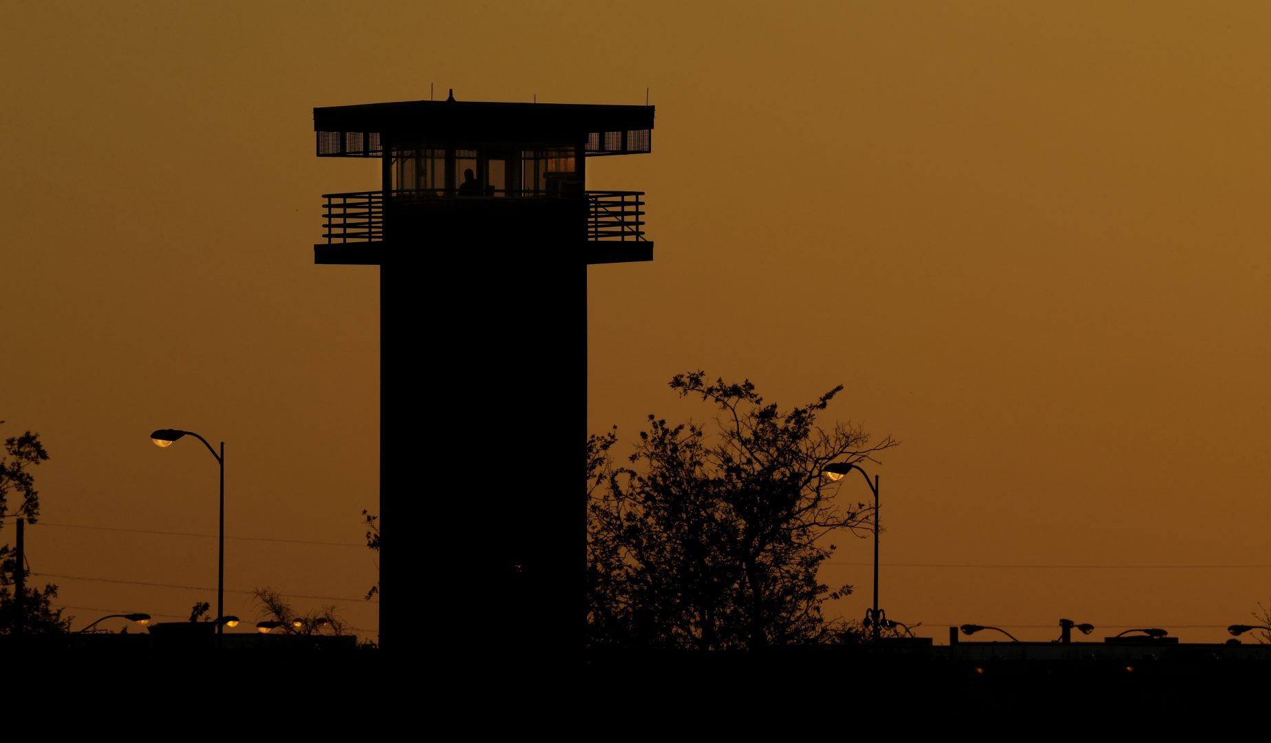 Part of the Texas Department of Criminal Justice's William G. McConnell Unit in Beeville, Texas, stands at sunset Wednesday, April 15, 2020. More than 26,000 people have been locked down in 22 Texas prisons that are keeping prisoners in their cells in an effort to contain the coronavirus, according to the TDCJ's most recent numbers. The McConnell Unit is not one of the 22. 