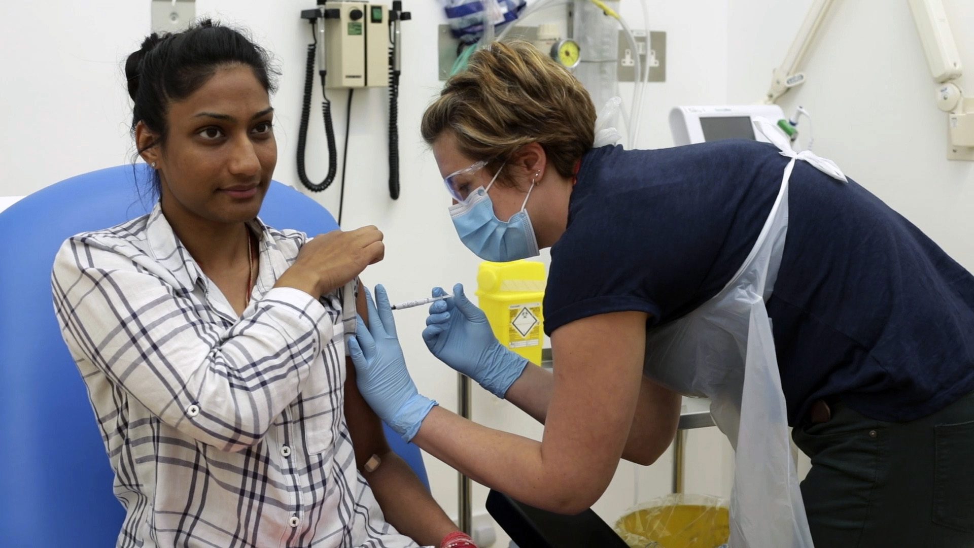 In this screen grab from video issued by Britain's Oxford University, a volunteer is injected with either an experimental COVID-19 vaccine or a comparison shot as part of the first human trials in the U.K. to test a potential vaccine, led by Oxford University in England on April 25, 2020. About 100 research groups around the world are pursuing vaccines against the coronavirus, with nearly a dozen in early stages of human trials or poised to start.