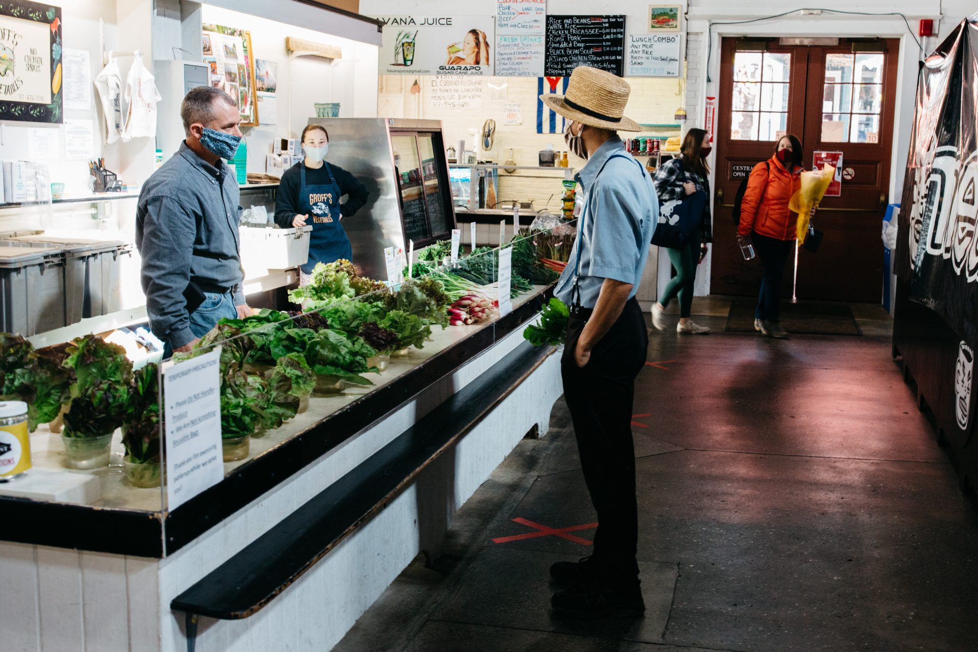 Vendors and shoppers don masks while at Lancaster Central Market on May 9, 2020.