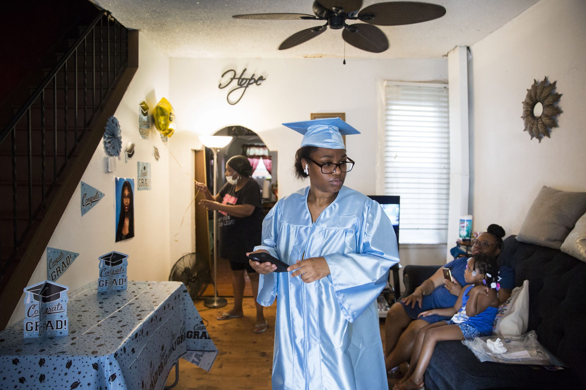 Aliah Harris (center) prepares for Paul Robeson High School's virtual graduation ceremony at her father's house in Grays Ferry on June 10, 2020.