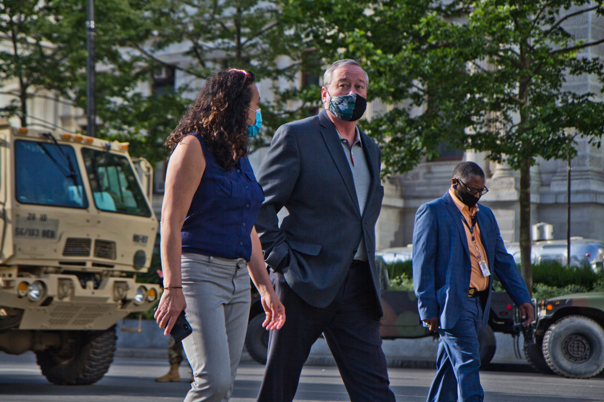 Philadelphia Mayor Jim Kenney (center) approaches the Municipal Services Building Wednesday. 