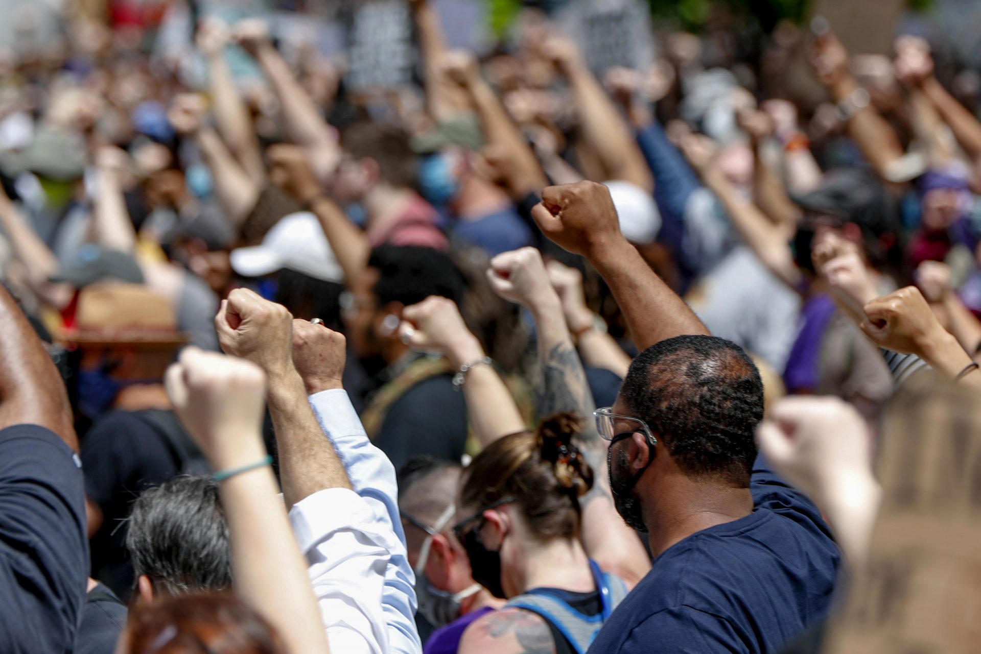 FILE - In this Saturday, May 30, 2020, file photo, demonstrators raise fists in the air during a march in Pittsburgh to protest the death of George Floyd, who died after being restrained by Minneapolis police officers on May 25.